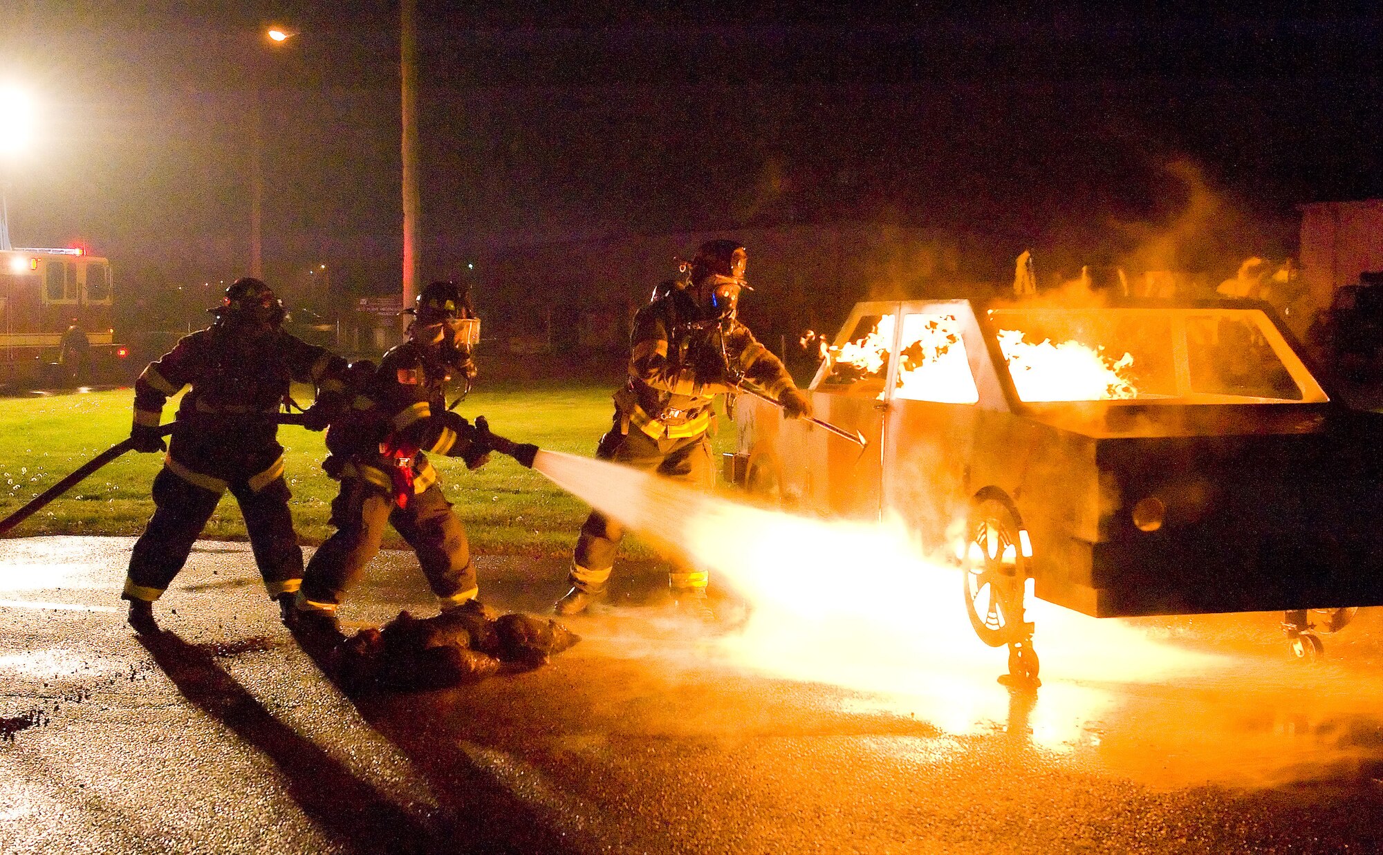 Firefighters with the 436th Civil Engineer Squadron extinguish a staged vehicle blaze during a Major Accident Response Exercise April 19, 2012, at Dover Air Force Base, Del. The MARE tested Team Dover's ability to respond to real-world incidents on base. (U.S. Air Force photo by Roland Balik)