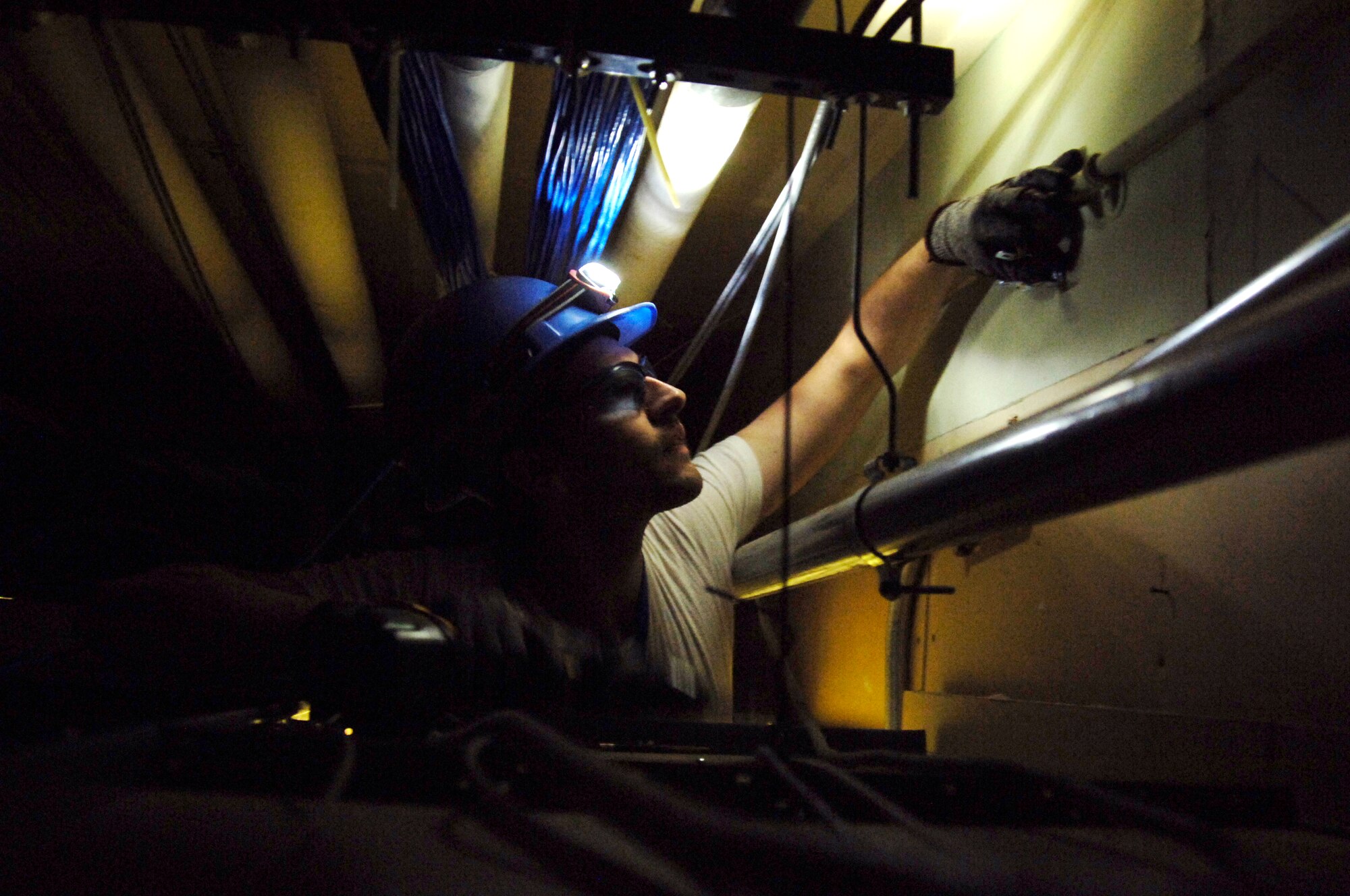 James Daves, an apprentice electrician with Oesco, mounts pipe above the ceiling tiles in the hallway of Bldg. 460, the 72nd Air Base Wing headquarters. The pipe will hold the wiring for “occupation sensors” which automatically turn the lights in an area on or off if they’re not being used. There are efforts under way in facilities Tinker-wide to create more energy efficient practices and approach work with a conservation-friendly mind set. Earth month is an opportunity to encourage changes that save taxpayers’ money and respect natural resources. (Air Force photo by Micah Garbarino)
