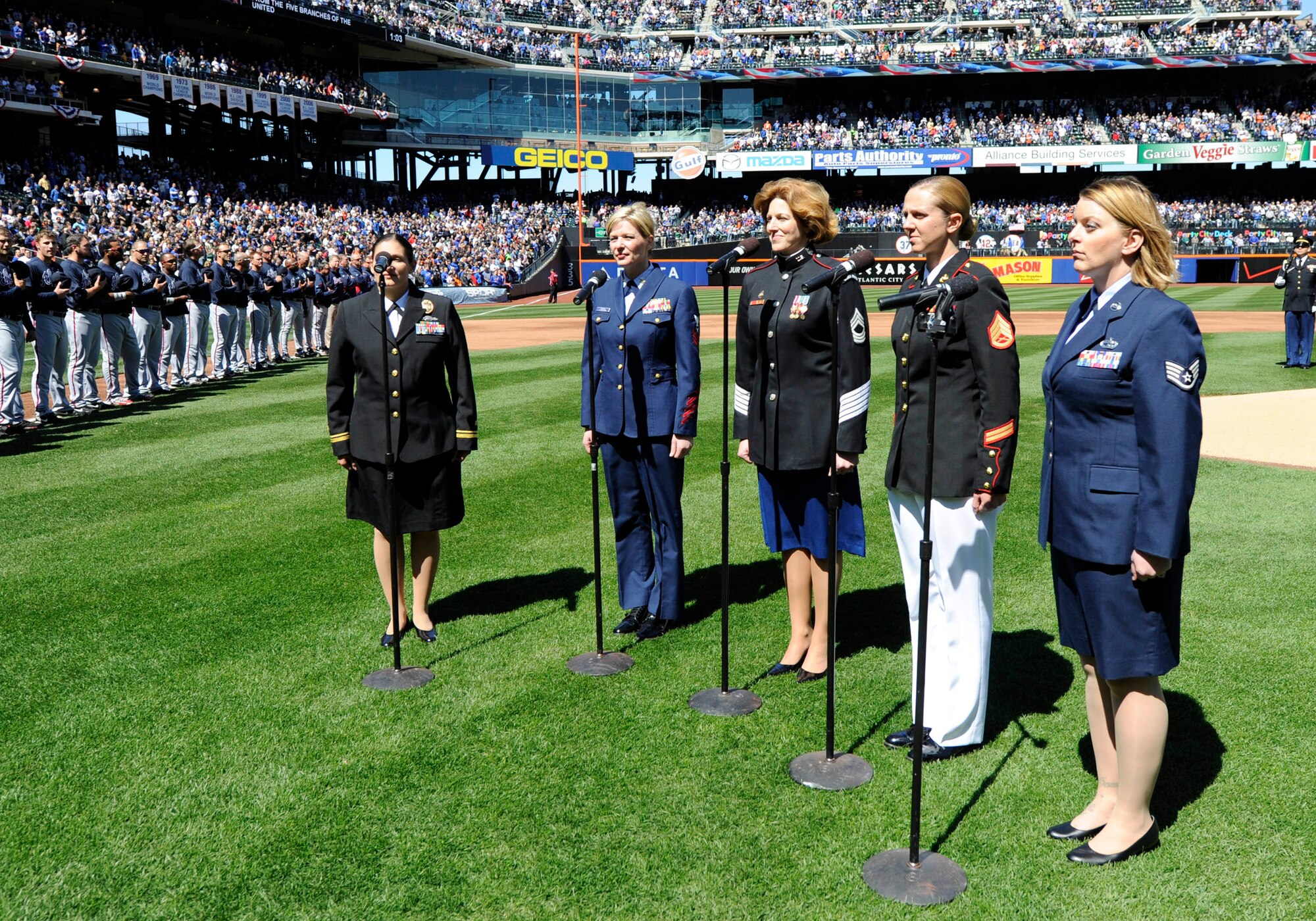 FLUSHING, N.Y.— Staff Sgt. Samantha Johnson (right), 314th Recruiting Squadron enlisted accessions recruiter, sang the National Anthem prior to the New York Mets vs. Atlanta Braves baseball game here April 5. Johnson was selected to sing the national anthem along with a female representative from each branch of the armed services. This is the first time Johnson has sung the national anthem at a professional sporting event. (Courtesy photo/Marc Levine)
