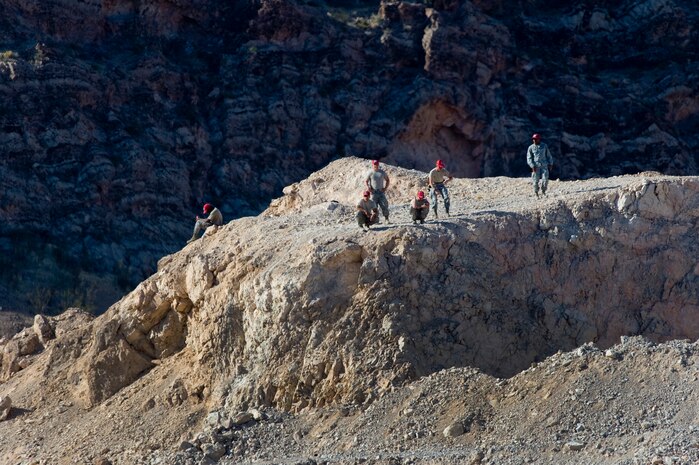 Airmen from the 823rd and 201st RED HORSE squadrons, wait on a mountain top while their instructors gather explosives, April 19, 2012, at Nellis Air Force Base, Nev.  The Airmen learned about quarry operations during a two week course.  (U.S. Air Force photo by Staff Sgt. William P.Coleman)  