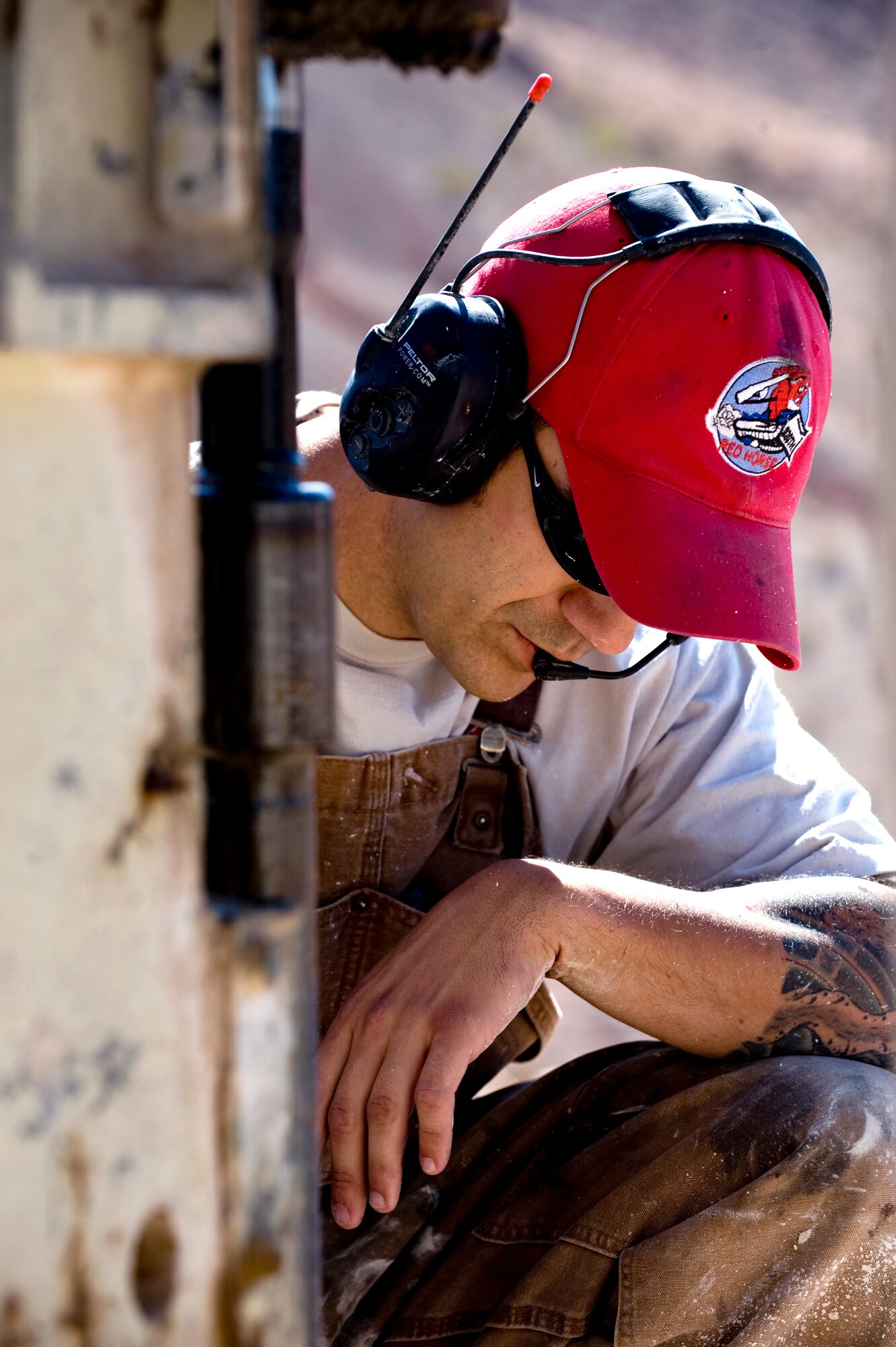 U.S. Air Force Tech. Sergeant Mark Ordway, 820th RED HORSE pavement and construction operator, monitors a drill while communicating with a student, April 17, 2012, at Nellis Air Force Base, Nev. Orway conducts quarry classes for every RED HORSE squadron in the Air Force.  (U.S. Air Force photo by Staff Sgt. William P.Coleman)
  

