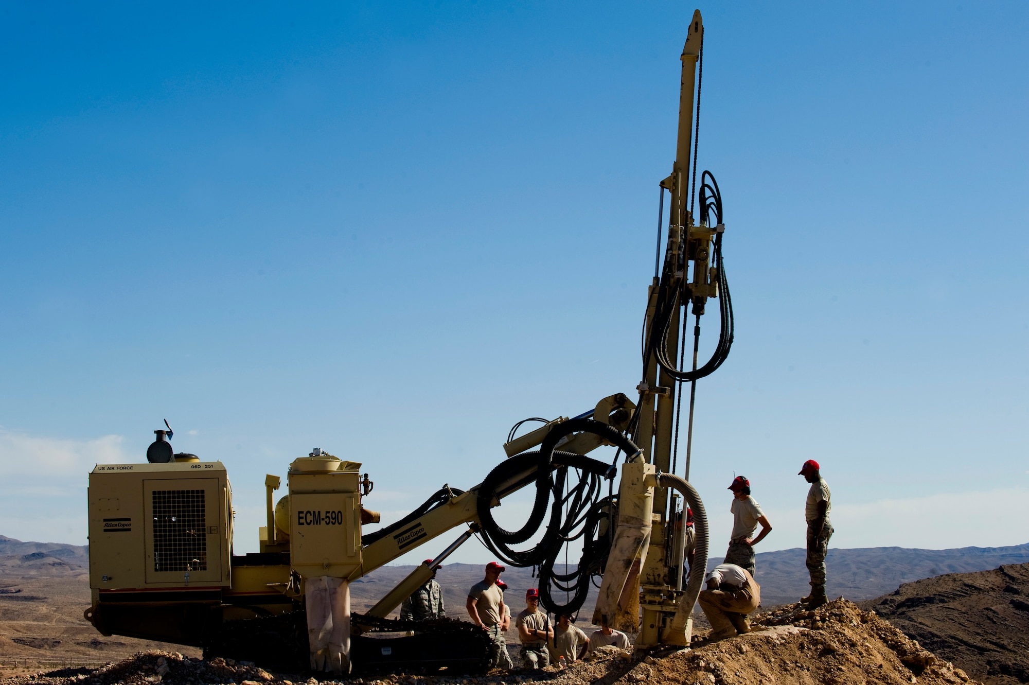 U.S. Air Force Airman from the 820th RED HORSE Squadron train Airman from the 823rd and 201st RED HORSE Squadrons on how to use a rock drill, April 17, 2012, at Nellis Air Force Base, Nev.  The rock drill can drill holes as deep as thirty feet.  (U.S. Air Force photo by Staff Sgt. William P.Coleman)
  

