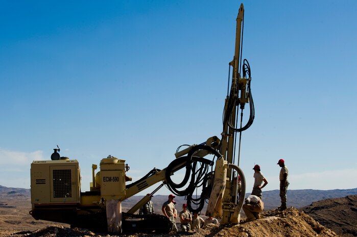 U.S. Air Force Airman from the 820th RED HORSE Squadron train Airman from the 823rd and 201st RED HORSE Squadrons on how to use a rock drill, April 17, 2012, at Nellis Air Force Base, Nev.  The rock drill can drill holes as deep as thirty feet.  (U.S. Air Force photo by Staff Sgt. William P.Coleman)  