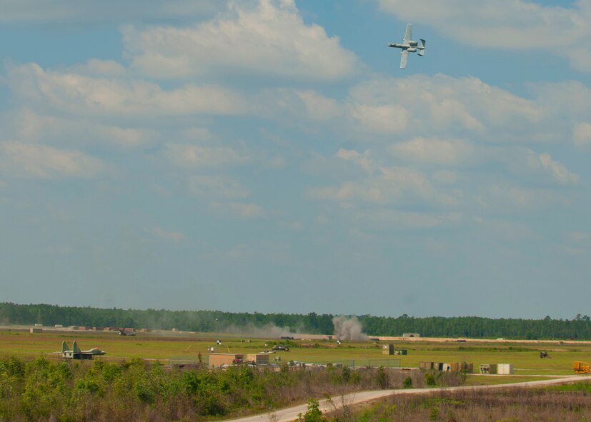 An A-10C Thunderbolt II demo team fires toward ground targets at the Grand Bay Bombing and Gunnery Range April 23, 2012 at Moody Air Force Base, Ga. The demo was held to show Italian distinguished visitors the A-10’s capabilities. (U.S. Air Force photo by Senior Airman Eileen Meier/Released)