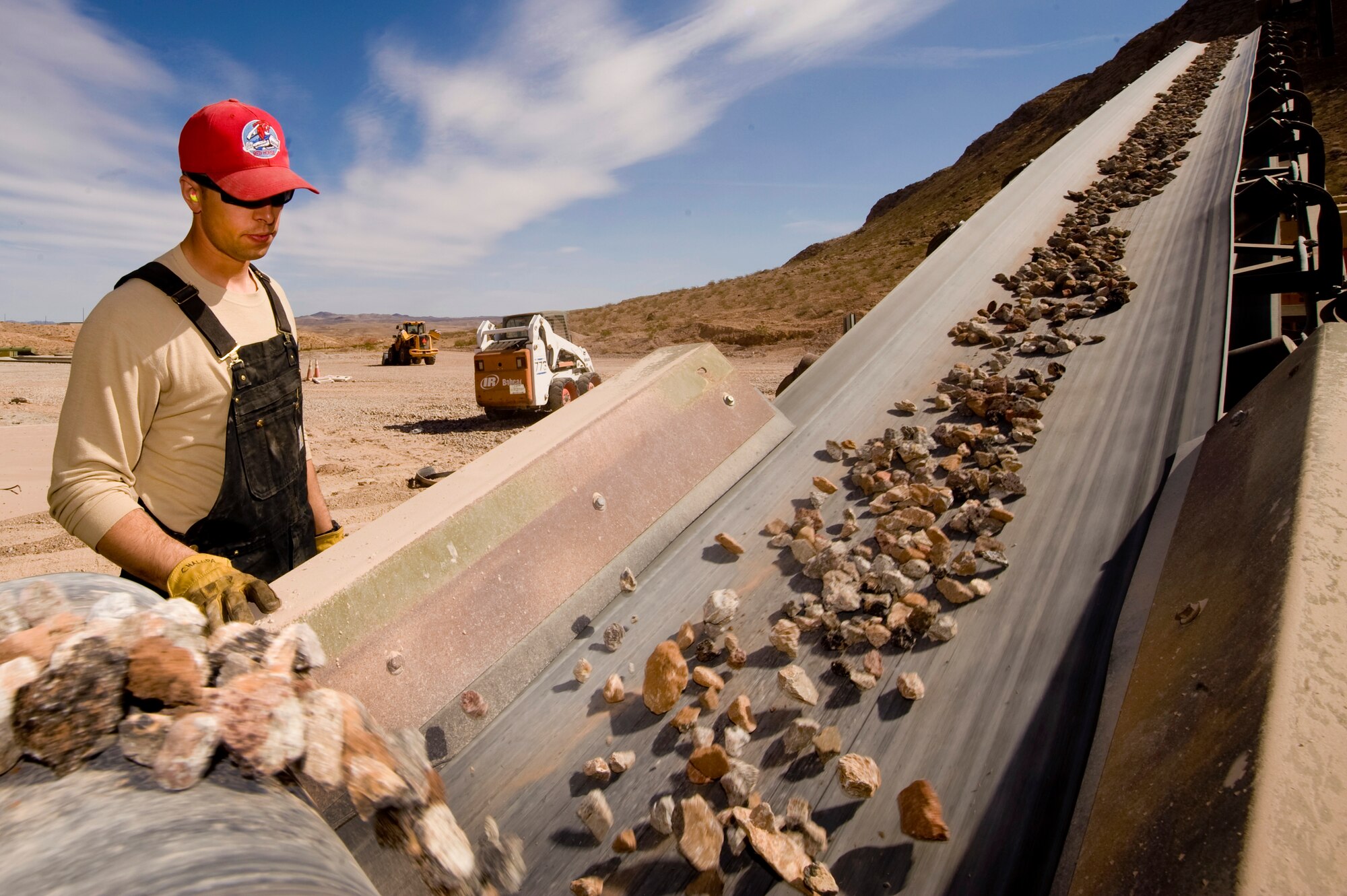 U.S. Air Force Staff Sgt. Steven Chalupnik, 820th RED HORSE pavement and construction craftsman, operates a rock crusher, Mar. 27, 2012, at Nellis Air Force Base, Nev. The rocks can be used for base course on road construction or landscaping.  (U.S. Air Force photo by Staff Sgt. William P.Coleman)
  

