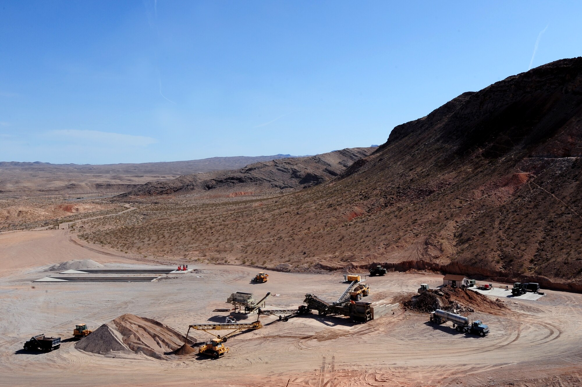 The 820th RED HORSE pavement and construction Airman make base course and ballast rock at their rock quarry, Mar. 27, 2012, at Nellis Air Force Base, Nev. Dust prevention measures ensure the site complies with Clark county regulations.  (U.S. Air Force photo by Staff Sgt. William P.Coleman)
  

