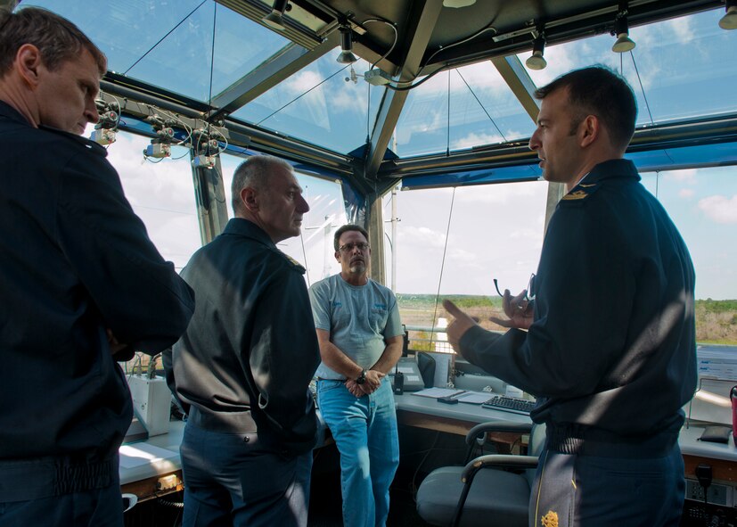 Italian air force Capitano (Capt.) Maurizio De Guida, 74th Fighter Squadron A-10C Thunderbolt II exchange pilot, right, shows the aerial gunning training targets from the Grand Bay Bombing and Gunnery Range tower to Colonello (Col.) Flavio Danielis, air attaché to the Italian embassy in D.C. and Generale di Brigata (Brig. Gen.) Roberto Nordio, Comando delle Forza da Combattimento Italian Air Force Combat Forces commander, April 23, 2012, at Moody Air Force Base, Ga. De Guida explained to Nordio and Danielis the A-10 training benefits of the exchange pilot program. (U.S. Air Force photo by Senior Airman Eileen Meier/Released)