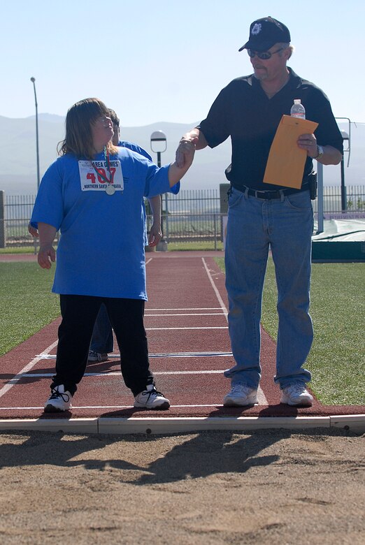 VANDENBERG AIR FORCE BASE, Calif. -- Patricia Ballew, a Special Olympics athlete, and her father Scott, prepare for the long jump during the Northern Santa Barbara County Special Olympics event at Pioneer Valley High School, Santa Maria Saturday, April 21, 2012. The Special Olympics competition is an international event that held their first summer games in Chicago, Ill. (U.S. Air Force photo/Staff Sgt. Andrew Satran) 

 
 