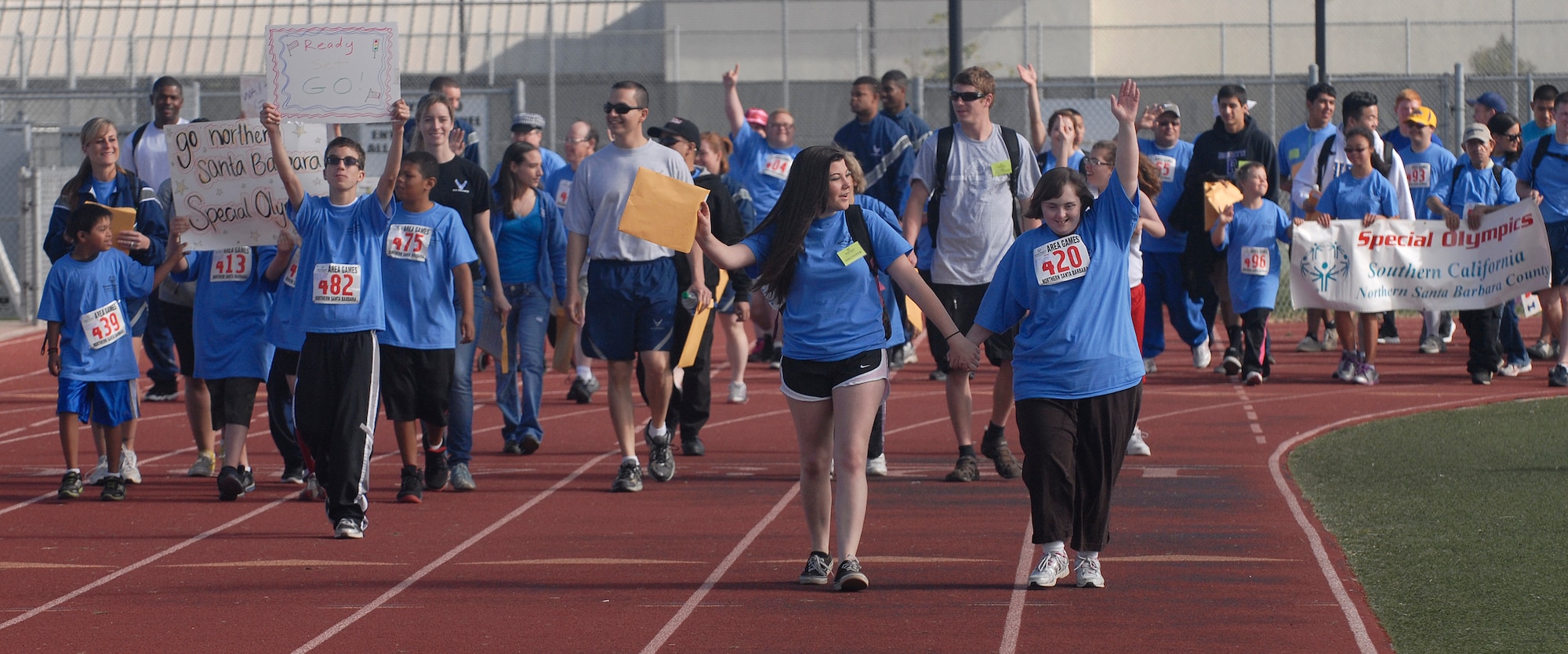 VANDENBERG AIR FORCE BASE, Calif. -- Team V volunteers and their athletes walk in a parade during the Northern Santa Barbara County Special Olympics event at Pioneer Valley High School, Santa Maria Saturday, April 21, 2012. Team V members have volunteered with the Northern Santa Barbara County Special Olympics for more than 30 years. More than 145 base volunteers from 19 organizations participated in the event this year. (U.S. Air Force photo/Staff Sgt. Andrew Satran) 

 