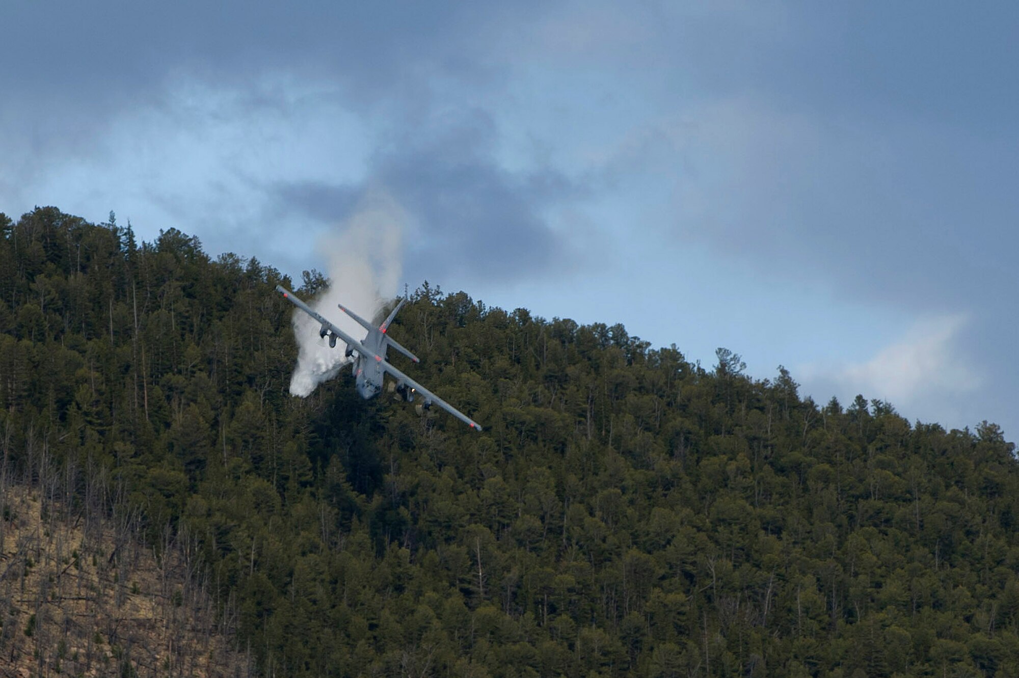 PETERSON AIR FORCE BASE, Colo -- A U.S. Air Force Reserve C-130 equipped with a U.S. Forest Service Modular Airborne Fire Fighting System II performs a practice water drop just above the trees in the Pike San Isabel National Forest in southern Colorado. In preparation for the upcoming 2012 wildland firefighting season, the U.S. Forest Service and Reservists from the 302nd Airlift Wing held their annual MAFFS re-certification and training, April 20-23 here. The training sponsored by the U.S. Forest Service and jointly conducted by the Air Force Reserve and U.S. Forest Service included 12 hours of ground and classroom training and 35 C-130 MAFFS training missions. (U.S. Air Force photo/Master Sgt. Adrian Cadiz) 