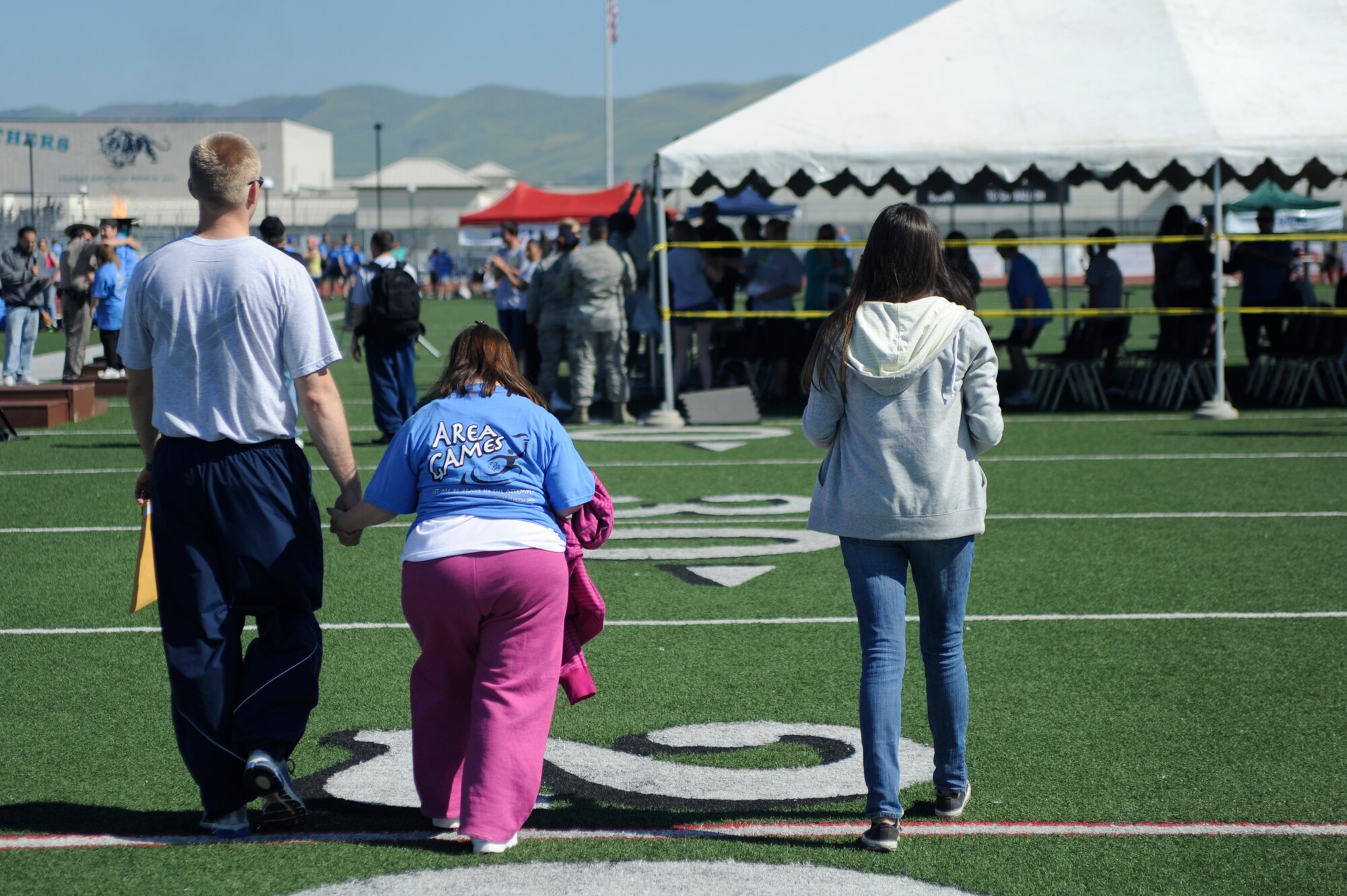 VANDENBERG AIR FORCE BASE, Calif. -- Airman 1st Class Bryan Wynkoop, a 533rd Training Squadron student, escorts Sharon Hanson, a Special Olympics athlete, during the Northern Santa Barbara County Special Olympics event at Pioneer Valley High School, Santa Maria Saturday, April 21, 2012. Team V members have volunteered with the Northern Santa Barbara County Special Olympics for more than 30 years. More than 145 base volunteers from 19 organizations participated in the event this year. (U.S. Air Force photo/Staff Sgt. Andrew Satran) 

 