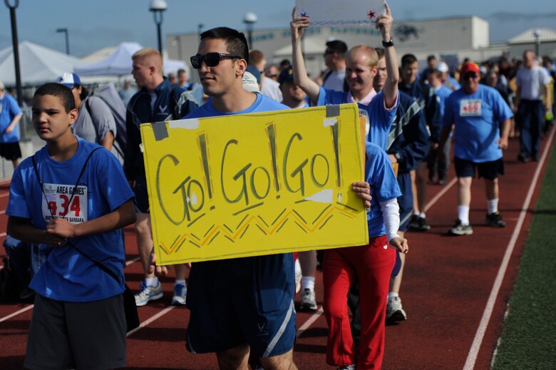 VANDENBERG AIR FORCE BASE, Calif. -- Team V volunteers and their athletes walk in a parade during the Northern Santa Barbara County Special Olympics event at Pioneer Valley High School, Santa Maria Saturday, April 21, 2012. Team V members have volunteered with the Northern Santa Barbara County Special Olympics for more than 30 years. More than 145 base volunteers from 19 organizations participated in the event this year. (U.S. Air Force photo/Staff Sgt. Andrew Satran)  