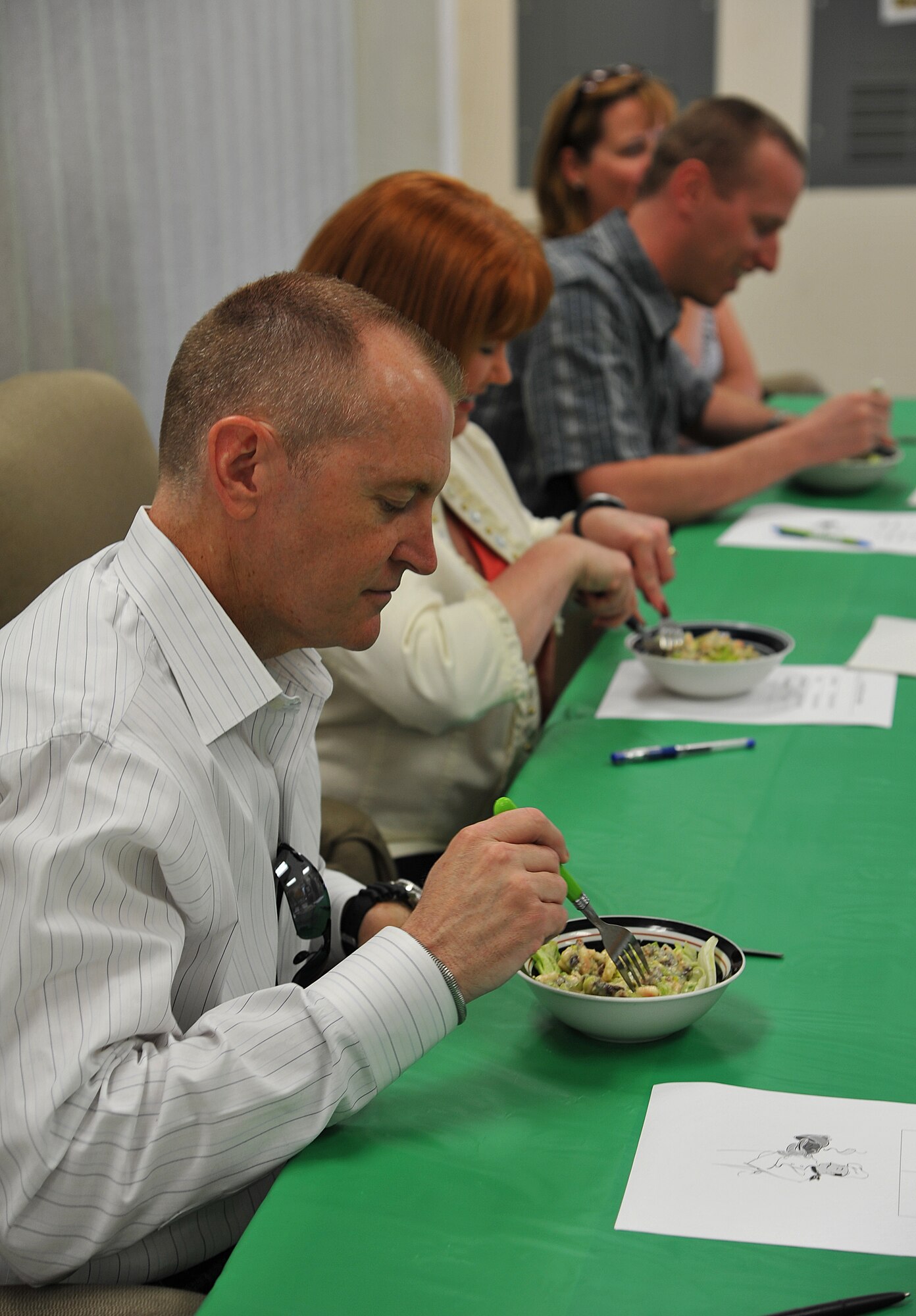 GOODFELLOW AIR FORCE BASE, Texas-- Chief Master Sgt. Scott Lumpkin, 17th Training Wing Command Chief, samples a dish during the 'Iron Chef' Goodfellow competition at Crossroads Student Center April 21. The judges graded each dish on creativity, taste, and presentation. (U.S. Air Force photo/ Airman 1st Class Michael Smith)
