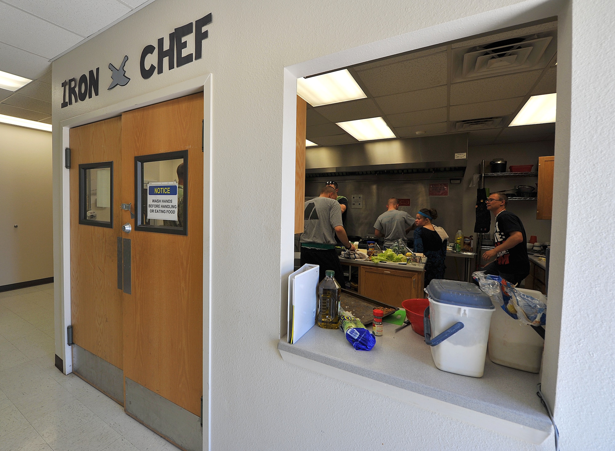 GOODFELLOW AIR FORCE BASE, Texas-- Participants cook during the 'Iron Chef' Goodfellow competition at the Crossroads Student Center April 21. Each team was given an hour to prepare three dishes using a secret ingredient. (U.S. Air Force photo/ Airman 1st Class Michael Smith)