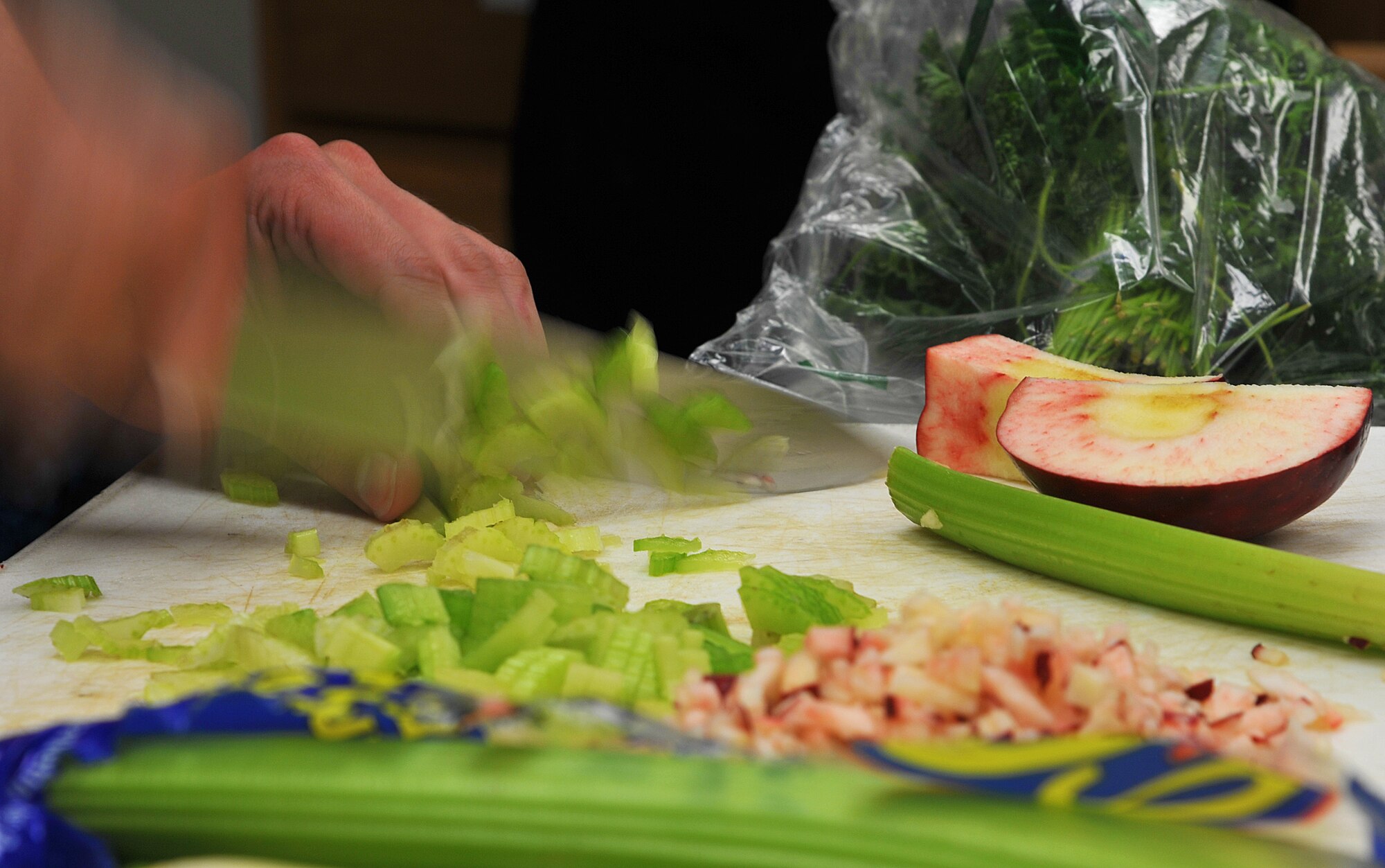 GOODFELLOW AIR FORCE BASE, Texas-- A participant chops celery during the 'Iron Chef' Goodfellow competition at the Crossroads Student Center April 21. The competition was hosted by the 17th Training Wing Chapel and lets students test their culinary skills against competitors. (U.S. Air Force photo/ Airman 1st Class Michael Smith)