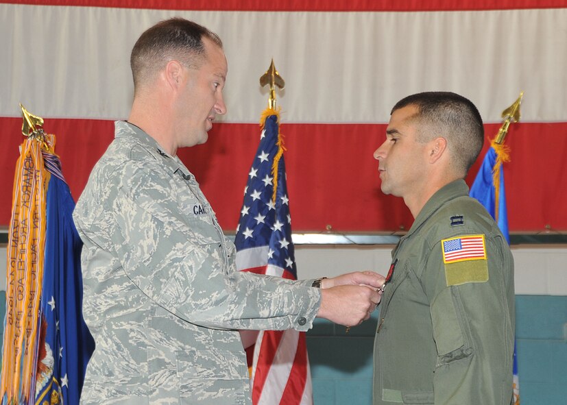 KIRTLAND AFB, N.M. -- Capt. Marcus Maris, 512th Rescue Squadron, was presented the Distinguished Flying Cross by Col. James Cardoso, 58th Special Operations Wing commander, during a ceremony here April 20. Maris received the medal for flying a high-risk mass-casualty evacuation mission in Afghanistan in 2010. The medal is awarded to servicemembers who distinguish themselves by heroism or extraordinary achievement while participating in an aerial flight in support of operations. (Photo by Todd Berenger)