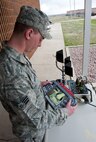 Senior Airman Luke Morse, 28th Civil Engineer Squadron explosive ordnance disposal journeyman, operates an Air Force Medium-Sized Robot during an improvised explosive device training scenario at the EOD building on Ellsworth Air Force Base, S.D., April 19, 2012. The training is designed to perfect the skills of the robot operator on the extensive features of the control box. (U.S. Air Force photo by Airman 1st Class Kate Thornton/Released)