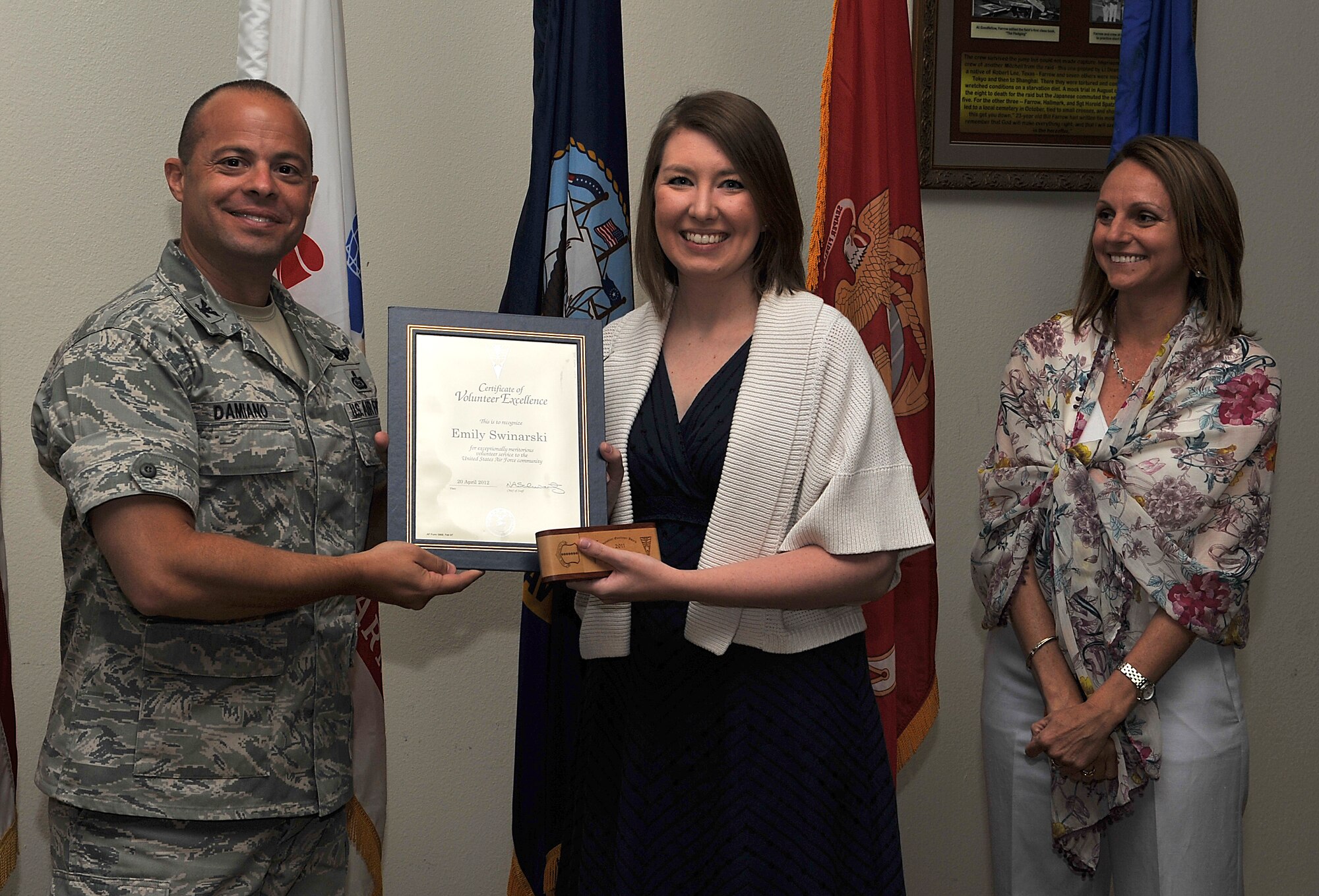 GOODFELLOW AIR FORCE BASE, Texas-- Emily Swinarski, Goodfellow Combined Spouse’s Club, is presented the Volunteer Excellence Award by Col. Mark Damiano, 17th Training Wing Commander, and his wife Ellery, April 20. This award was established to recognize federal civilians, family members and military retirees who perform outstanding volunteer community. (U.S. Air Force photo/ Airman 1st Class Michael Smith)