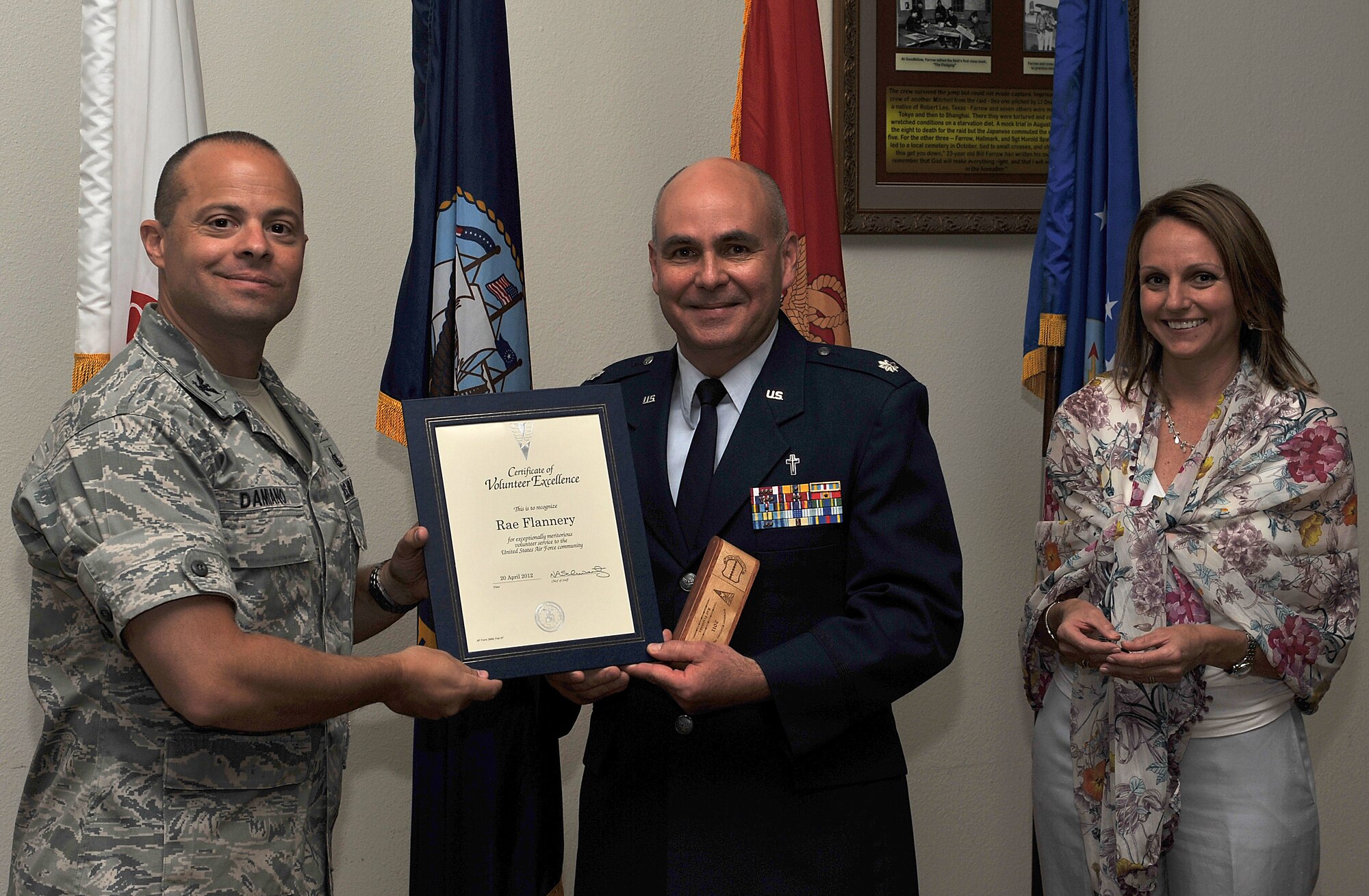 GOODFELLOW AIR FORCE BASE, Texas-- Lt. Col Bruce Glover, 17th Training Support Chaplain, accepts the Volunteer Excellence Award on behalf of Rae Flannery, 17th Training Wing Chapel, given by Col. Mark Damiano, 17th Training Wing Commander, and his wife Ellery, April 20. This award was established to recognize federal civilians, family members and military retirees who perform outstanding volunteer community. (U.S. Air Force photo/ Airman 1st Class Michael Smith)