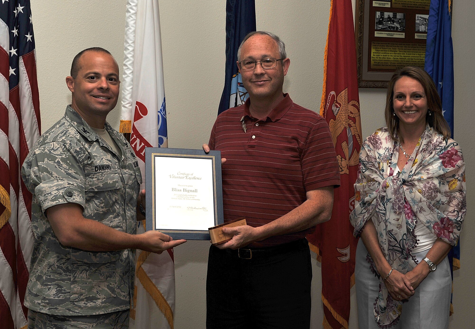 GOODFELLOW AIR FORCE BASE, Texas-- Bliss Bignall, 17th Training Support Squadron, is presented the Volunteer Excellence Award by Col. Mark Damiano, 17th Training Wing Commander, and his wife Ellery, April 20. This award was established to recognize federal civilians, family members and military retirees who perform outstanding volunteer community. (U.S. Air Force photo/ Airman 1st Class Michael Smith)