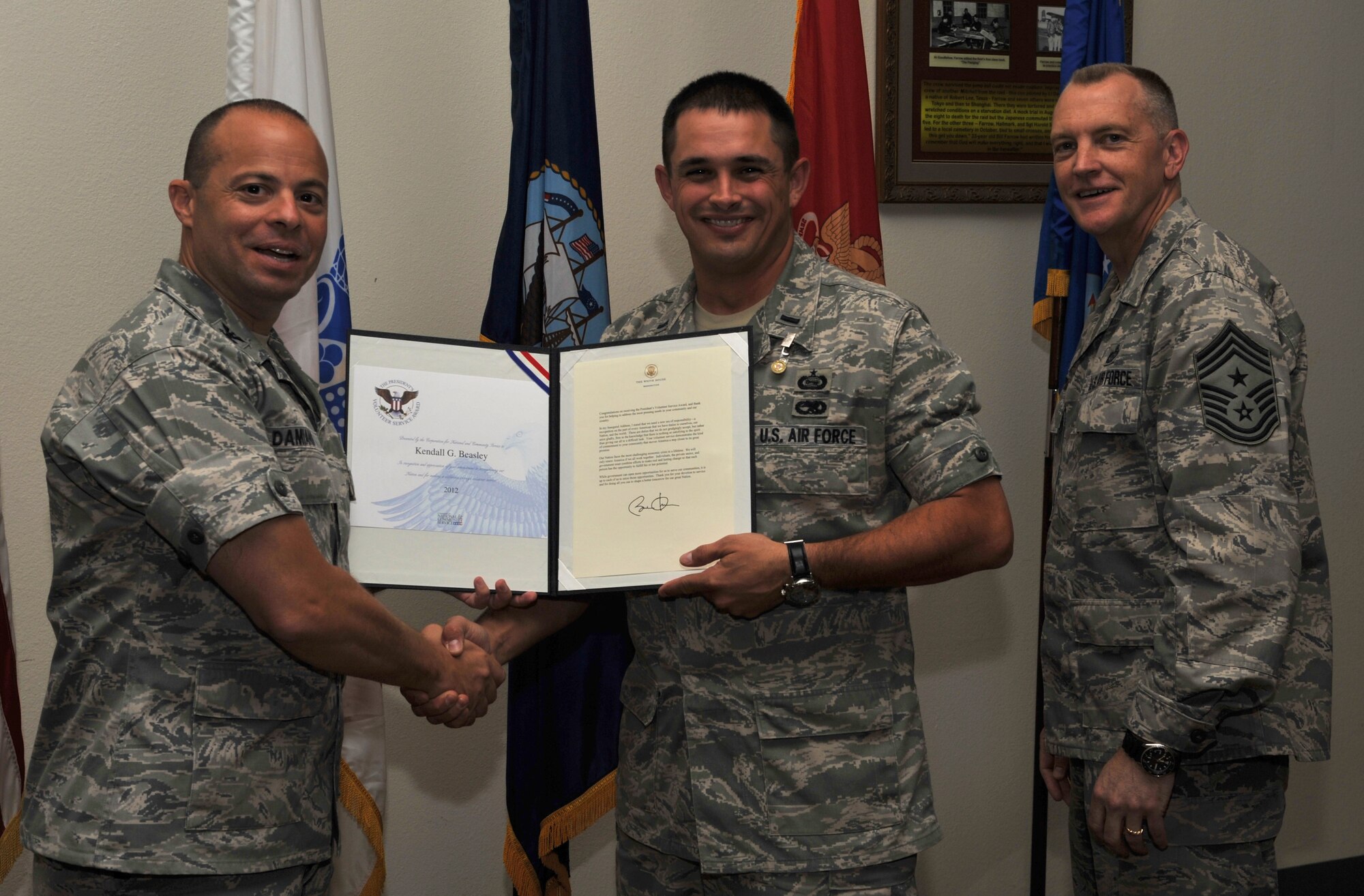 GOODFELLOW AIR FORCE BASE, Texas-- 2nd Lt. Kendall Beasley, 315th Training Squadron, is presented the Presidential Volunteer Service Bronze Level Award by Col. Mark Damiano, 17th Training Wing Commander, and Chief Master Sgt. Scott Lumpkin, 17th Training Wing Command Chief, April 20. The Bronze level award is presented to adults who have accomplished 100 to 174 hours of volunteering. (U.S. Air Force photo/ Airman 1st Class Michael Smith)