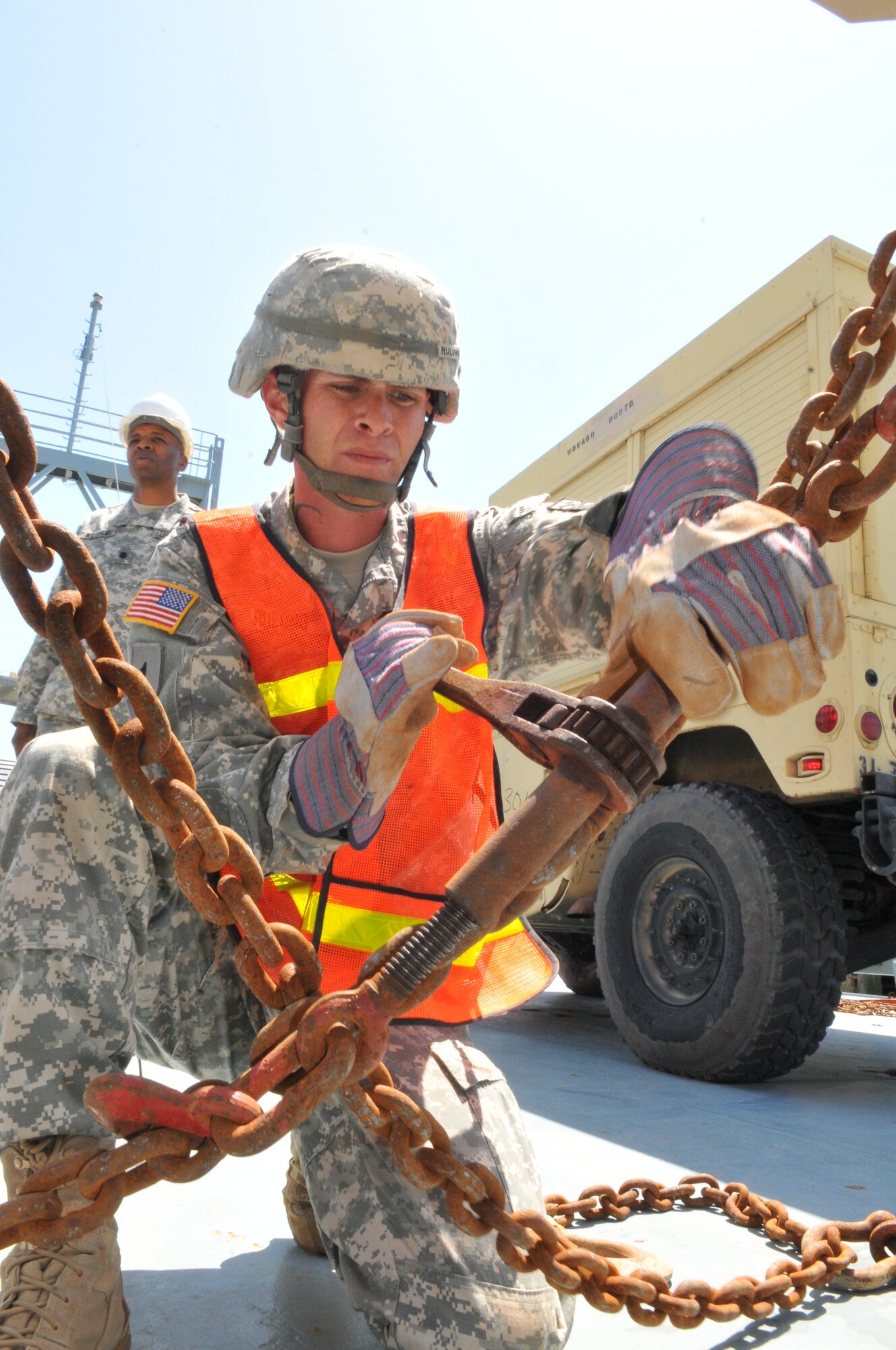 U.S. Army Spc. John Rulong, a transportation specialist assigned to the 359th Inland Cargo Transfer Company, 10th Transportation Battalion, 7th Sustainment Brigade, chains a vehicle to the deck of the Landing Craft Utility 2011 ‘Chickahominy’ while it was docked in Savannah, Ga., April 11, 2012. (U.S. Army photo by Staff Sgt. Alexander Burnett/Released)