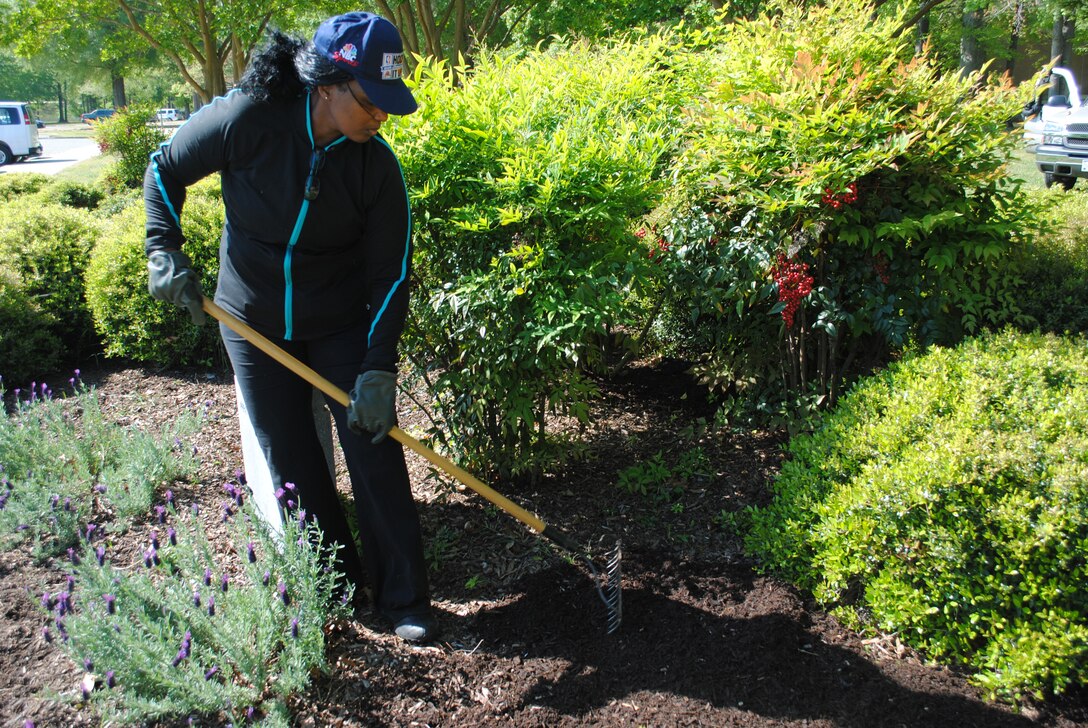 U.S. Army Sgt. 1st Class Cheryl Jackson, with the 93rd Signal Brigade, spreads mulch around a flower bed at Fort Eustis April 16, during the first day of Earth Week activities. Jackson was part of a group of nearly 45 volunteers who came together Monday to kick off Joint Base Langley-Eustis’ Earth Week activities. (Courtesy photo by Toni Guagenti/Released)