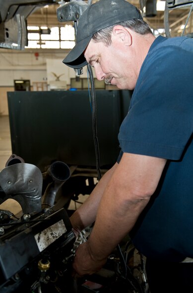 Randel West, 7th Logistics Readiness Squadron, repairs a Ford 6.0 diesel engine April 19, 2012, at Dyess Air Force Base, Texas. West created a solution to conduct in-house, cab-off engine repairs on Ford Power Stroke engines, saving the Air Force $5,000 per vehicle repair and tightening quality control measures. (U.S. Air Force photo by Airman 1st Class Jonathan Stefanko/ Released)