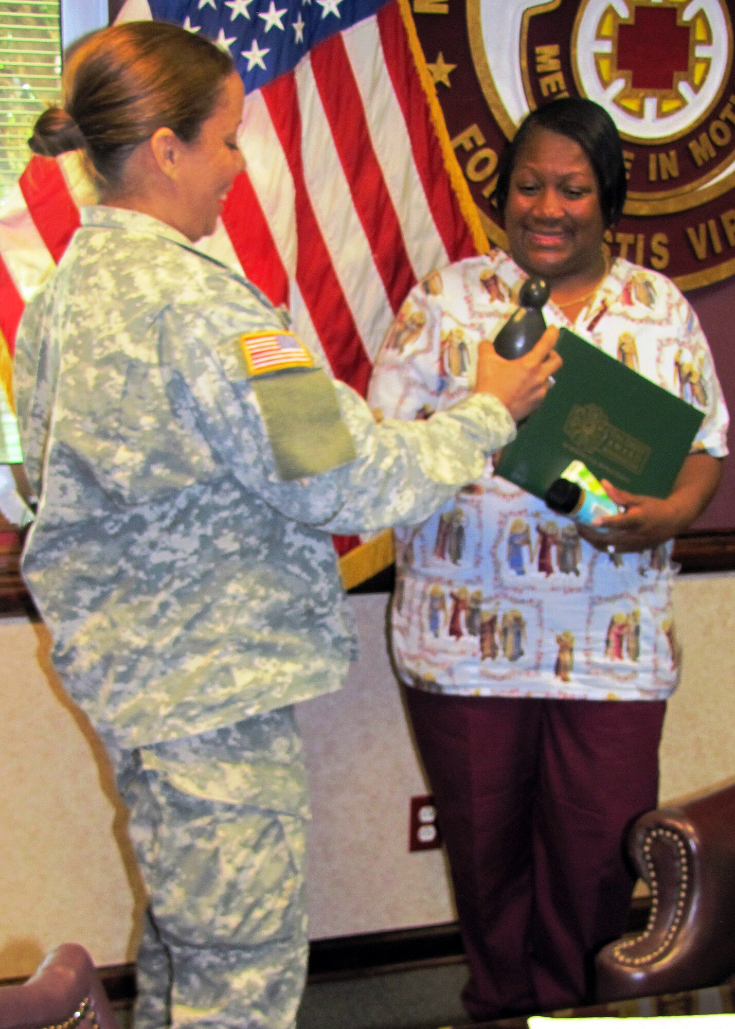 Joann Bright Barnes, McDonald Army Health Center nurse, accepts the DAISY award for the first quarter of 2012. The “Diseases Attacking the Immune System” award is presented quarterly to an outstanding nurse nominated by his/her peers, co-workers and family members. (Courtesy photo)