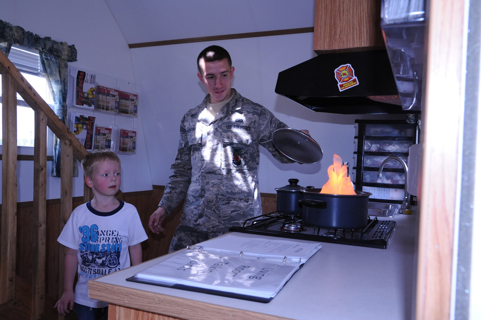 Senior Airman Daniel McIntire, 436th Civil Engineer Squadron fire department, discusses fire safety with 5 year-old Daniel Bradley during the Youth Center?s ?Month of the Military Child and Child Abuse Prevention Carnival? April 21, 2012, at Dover Air Force Base, Del. The carnival offered free food, games, prizes and music. (U.S. Air Force photo by Staff Sgt. Chad Padgett)