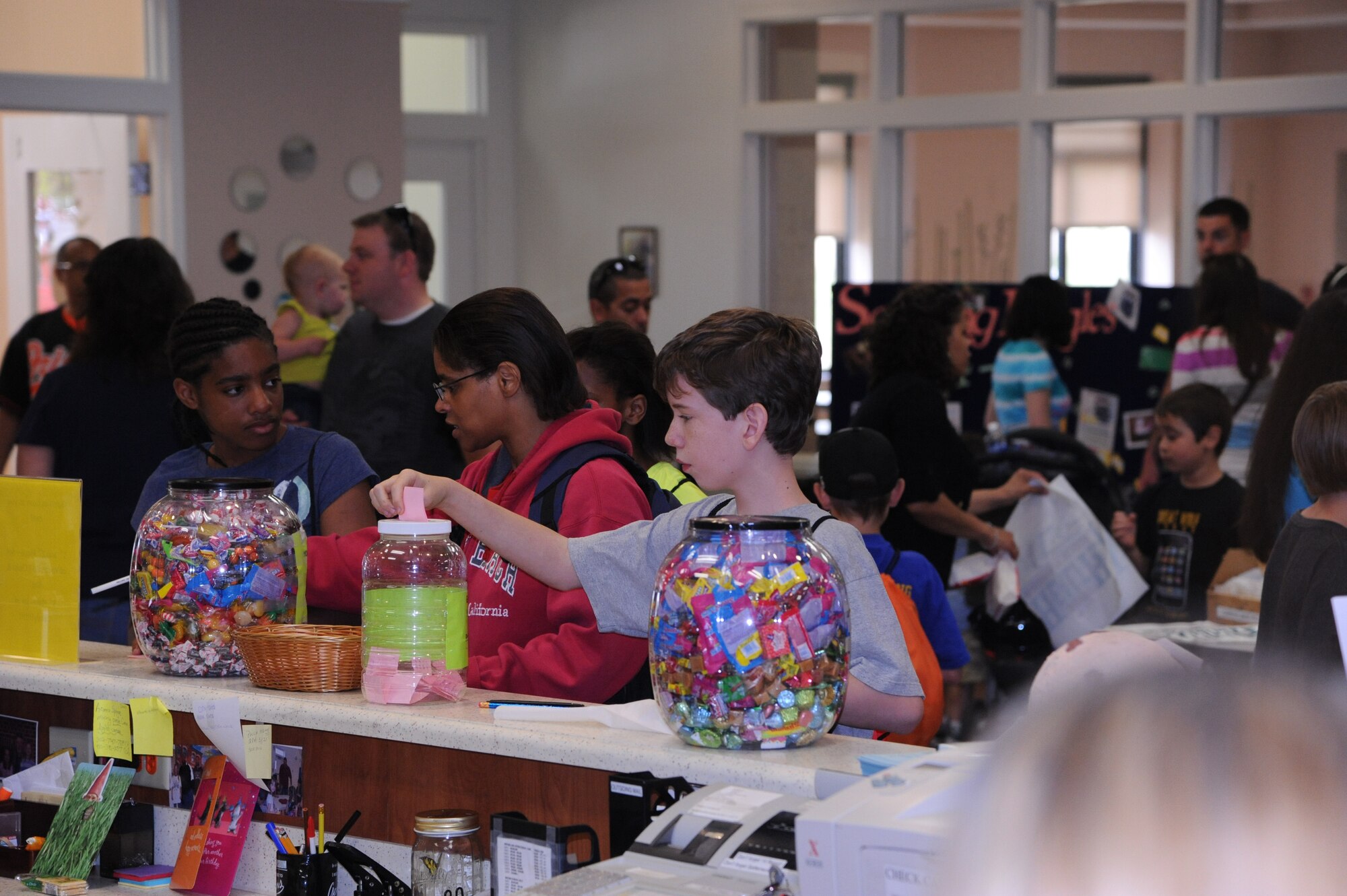 Children participate in the ?Guess the amount of candy in the jar? game at the Youth Center?s ?Month of the Military Child and Child Abuse Prevention Carnival? April 21, 2012, at Dover Air Force Base, Del. The winner won the jars of candy.  The carnival offered free food, games, prizes and music. (U.S. Air Force photo by Staff Sgt. Chad Padgett)