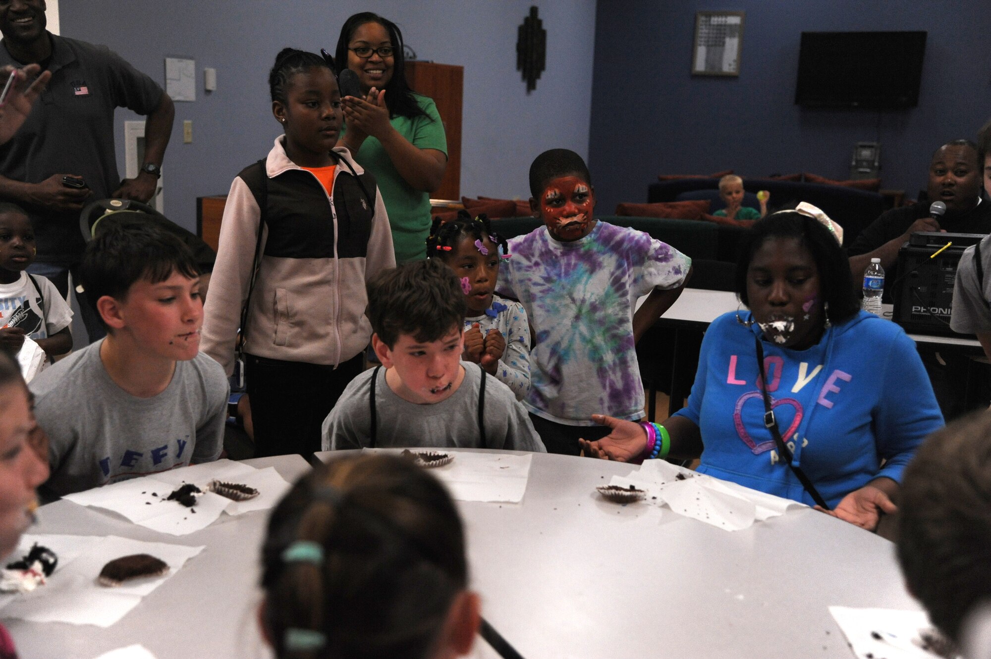Children participate in the cupcake eating challenge during the Youth Center?s ?Month of the Military Child and Child Abuse Prevention Carnival? April 21, 2012, at Dover Air Force Base, Del.  The carnival offered free food, games, prizes and music. (U.S. Air Force photo by Staff Sgt. Chad Padgett)
