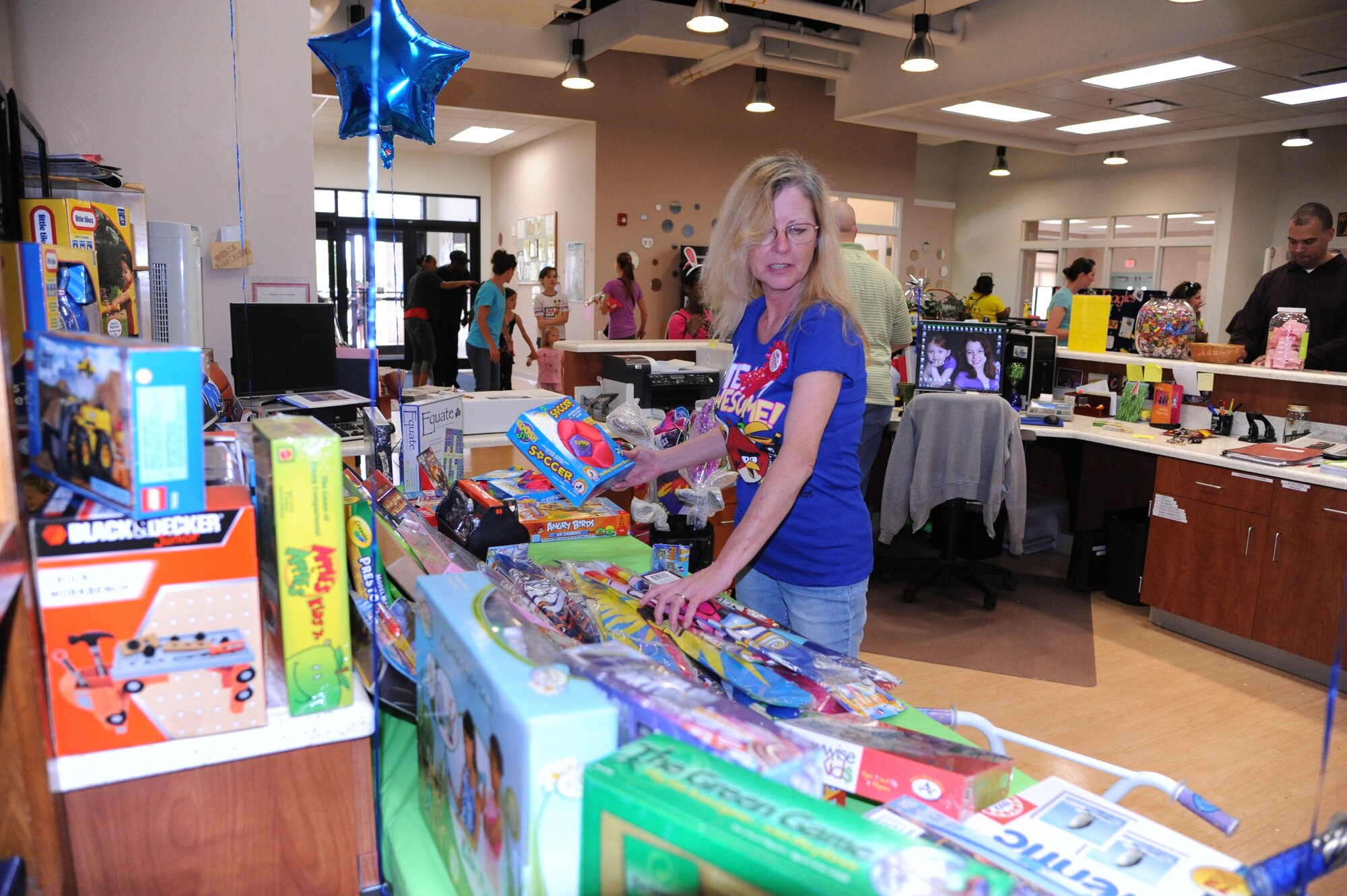 Beni Minner, Youth Center clerk, sets up the prize give-away table for the Youth Center?s ?Month of the Military Child and Child Abuse Prevention Carnival? April 21, 2012, at Dover Air Force Base, Del.  Prizes were given out randomly throughout the carnival.  (U.S. Air Force photo by Staff Sgt. Chad Padgett)