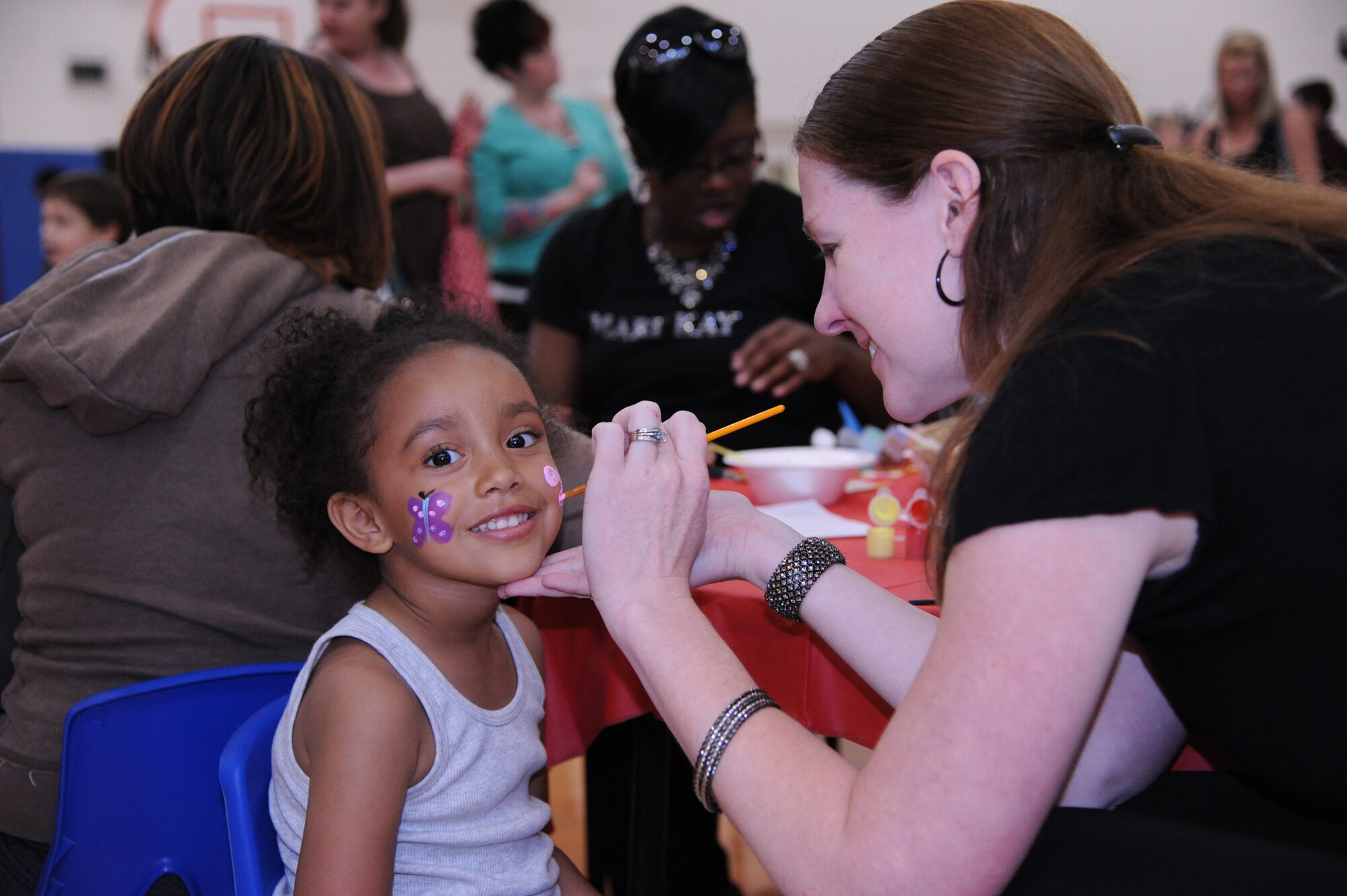 Akayla Mosley, 4, gets her face painted during the Youth Center?s ?Month of the Military Child and Child Abuse Prevention Carnival? April 21, 2012, at Dover Air Force Base, Del.  The carnival offered free food, games, prizes and music. (U.S. Air Force photo by Staff Sgt. Chad Padgett)