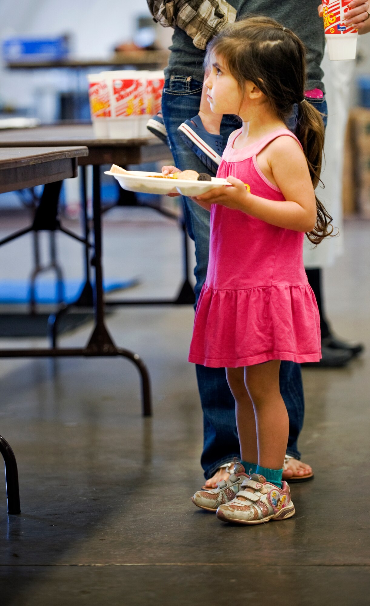 Sarah Scaglione, 3, waits to receive food during the 47th annual World’s Largest BBQ April 21, 2012, at the Civic Center in Abilene, Texas. The World’s Largest BBQ is sponsored by the Abilene Chamber of Commerce to show appreciation by providing free food to active-duty members, retired military and dependents. (U.S. Air Force photo by Airman 1st Class Jonathan Stefanko/ Released)
