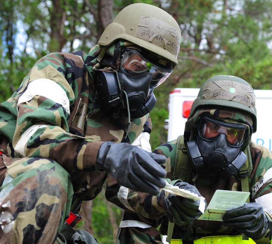 U.S. Air Force Lt. Col. Brian Ortman, left, 1st Fighter Wing Public Health commander, and Maj. Greg Garrison, right, 633rd Aerospace Medicine Squadron Bio-Environmental Engineering Flight commander, perform a post-attack reconnaissance sweep during a Phase II Operational Readiness Exercise at Langley Air Force Base, Va., April 20, 2012.  The Phase II ORE evaluates the unit’s ability to Employ the Force, Sustain the Force, and the Ability to Survive and Operate in a deployed environment.   (U.S. Air Force photo by Airman 1st Class Kayla Newman/Released)