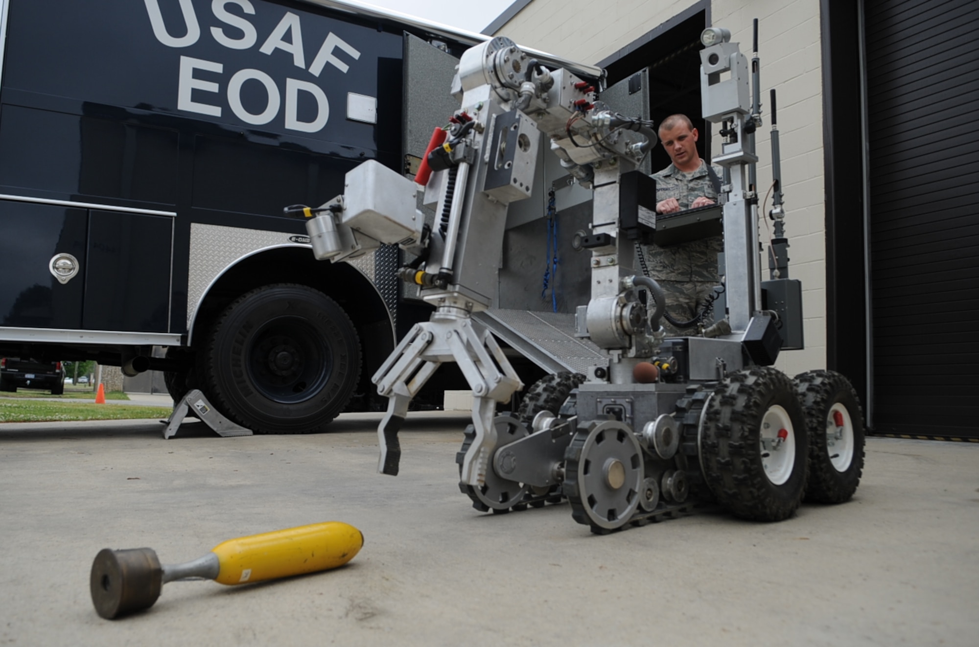 U.S. Air Force Airman 1st Class Graham Speight attempts to pick up a training mortar with the Remotec ANDROS F6A robot on Seymour Johnson Air Force Base, N.C., April 19, 2012. Explosive Ordnance Disposal Airmen often rely on the F6A robot to help ensure a safe, successful outcome for emergency missions. Speight, 4th Civil Engineer Squadron EOD apprentice, hails from New Bern, N.C. (U.S. Air Force photo/Airman 1st Class Aubrey Robinson/Released) 