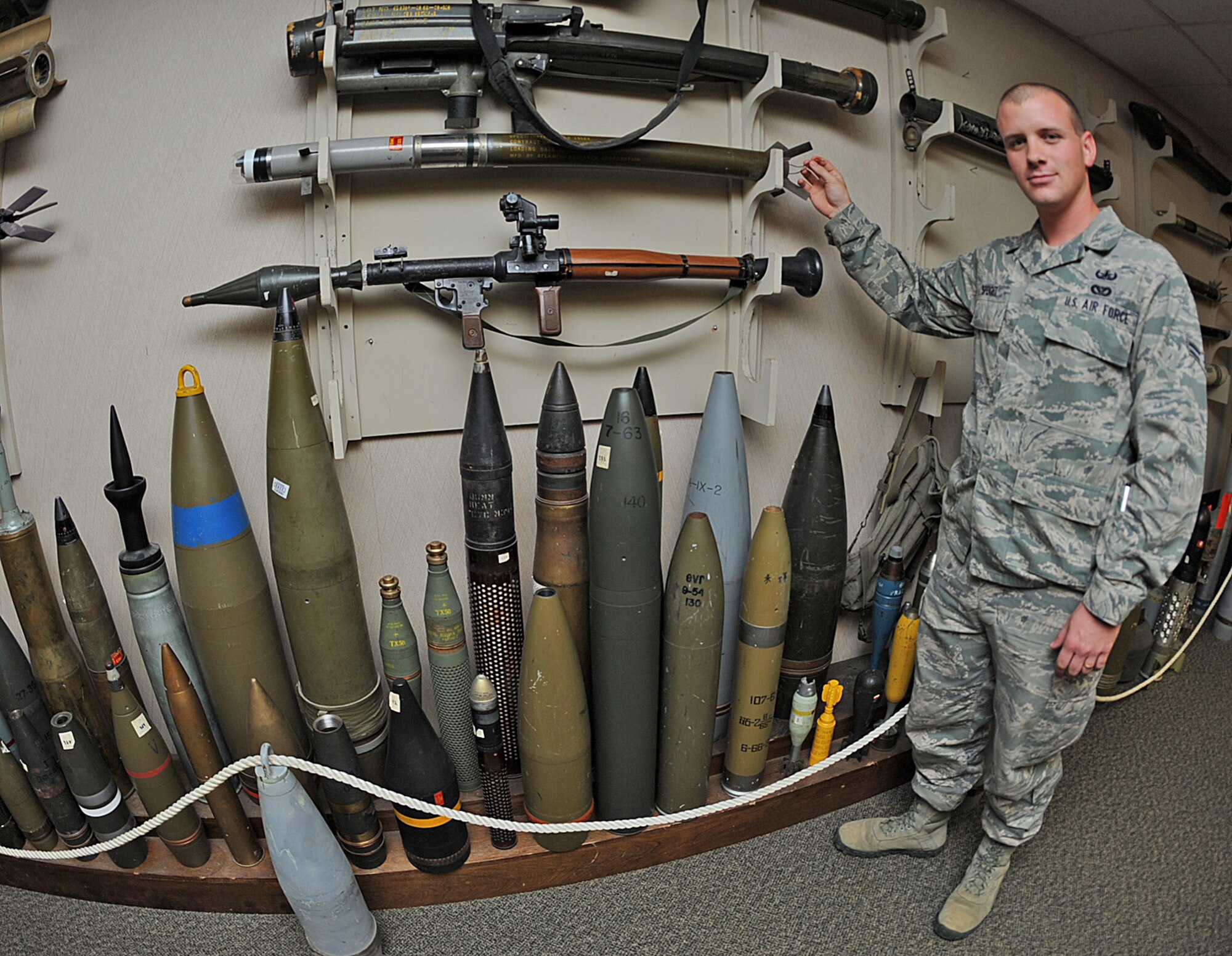 U.S. Air Force Airman 1st Class Graham Speight shows the differences between explosive ordnance devices on Seymour Johnson Air Force Base, N.C., April 19, 2012. EOD apprentices and technicians must know the differences between each device to ensure proper classification prior to disposal. Speight, 4th Civil Engineer Squadron EOD apprentice, hails from New Bern, N.C. (U.S. Air Force photo/Airman 1st Class Aubrey Robinson/Released)