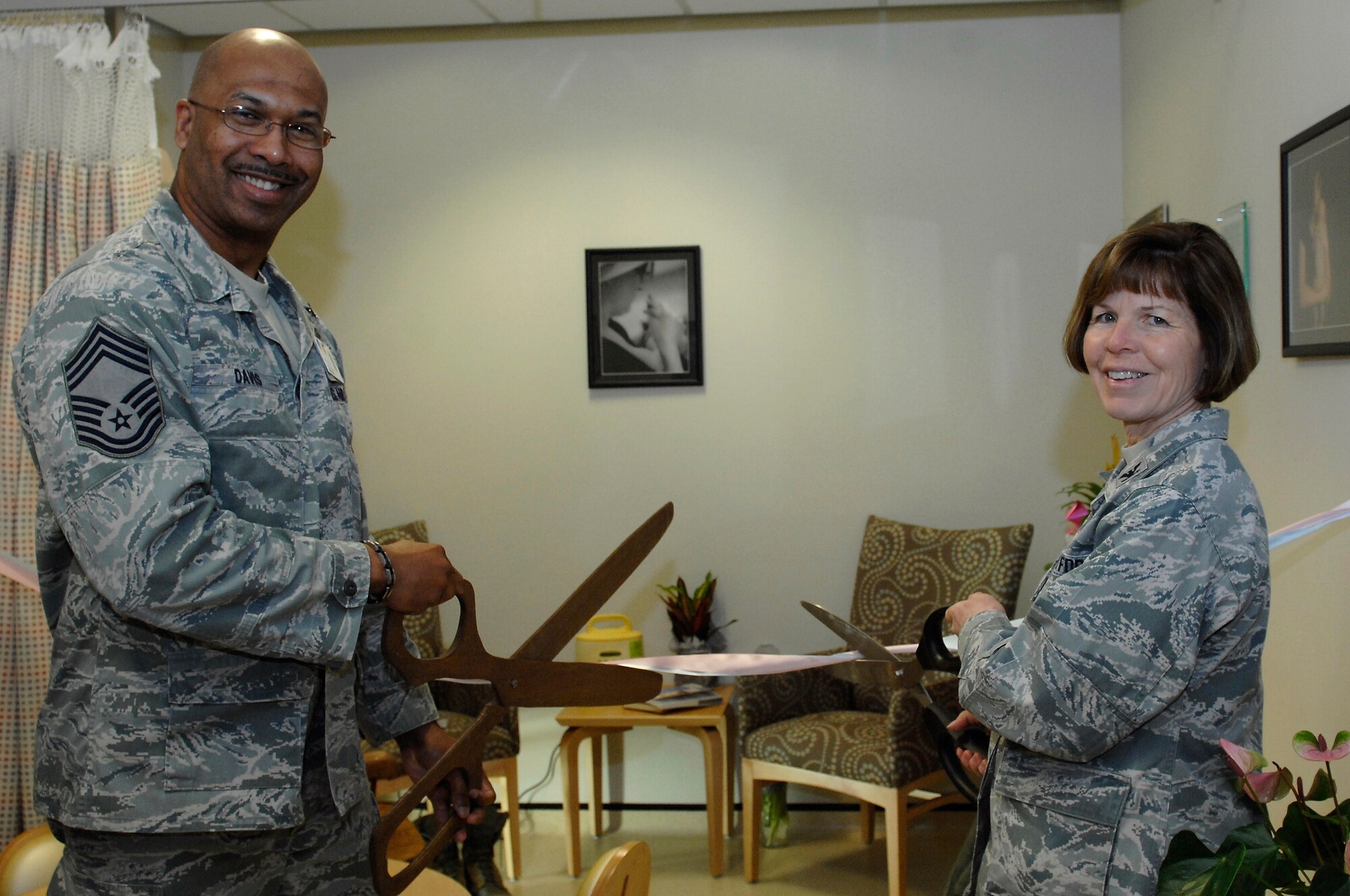 ROYAL AIR FORCE LAKENHEATH, England -- Chief Master Sgt. Tyrone Davis, 48th Medical Group superintendent, and Col. Consuella Pockett, 48th MDG deputy commander, prepare to open the 48th MDG’s first designated private breast feeding area within the hospital April 19, 2012.  Families gathered at the obstetrics clinic for the dedication and tour.  (U.S. Air Force photo by Tech. Sgt. Lee A. Osberry Jr.)