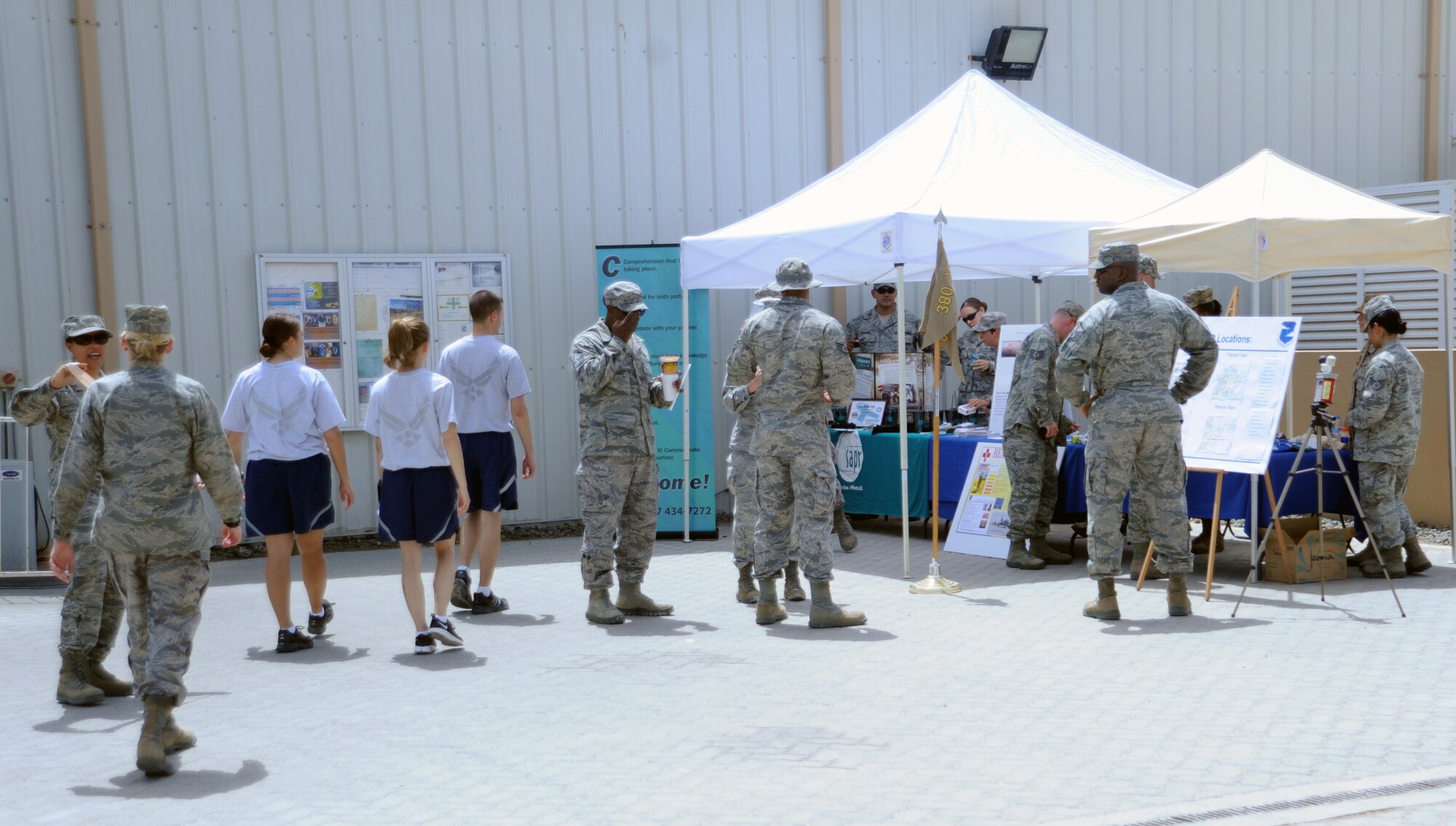 SOUTHWEST ASIA - Airmen of the 380th Air Expeditionary Wing head to a fair hosted by medical professionals deployed here. The medical staff answered questions and offered tips to staying healthy during the summer months. (U.S. Air Force photo/Staff Sgt. J.G. Buzanowski)