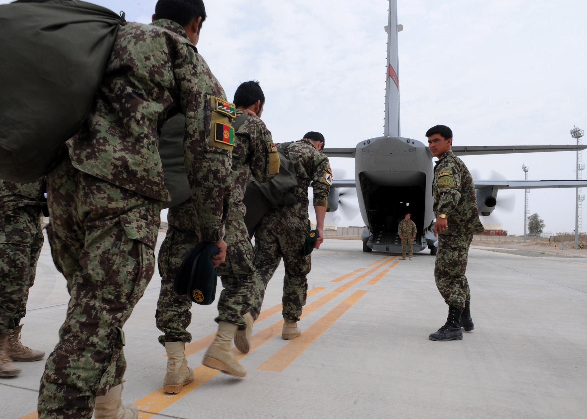 Passengers load a C-27 Spartan aircraft after being processed through a security check point by the Afghan air force aerial port personnel at the AAF passenger terminal at Kandahar Air Wing, Afghanistan, April 18, 2012. Advisers from the 738th Air Expeditionary Advisory Group air transportation section are currently training the AAF to manage all cargo and passengers that flow through the KAW AAF passenger terminal. (U.S. Air Force photo by Staff Sgt. Nadine Y. Barclay)