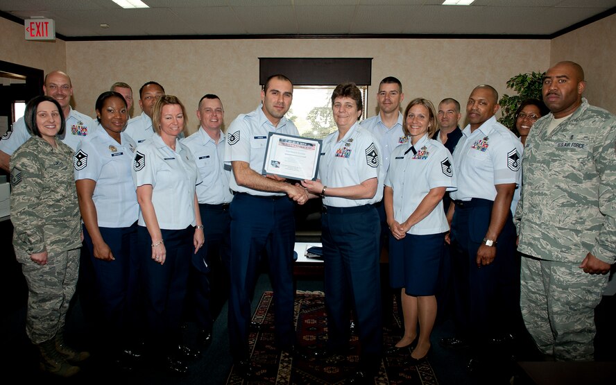 Tech. Sgt. Hussein Hamdan, 39th Air Base Wing protocol, receives the Unsung Hero Award from Chief Master Sgt. Nancy Judge, 39th Air Base Wing command chief and members of the Incirlik Top 3 April 23, 2011, at Incirlik Air Base, Turkey. The Top 3 presents this award monthly to Airmen who demonstrate superior job performance and exceptional leadership. (U.S. Air Force photo by Senior Airman Jarvie Z. Wallace/Released)