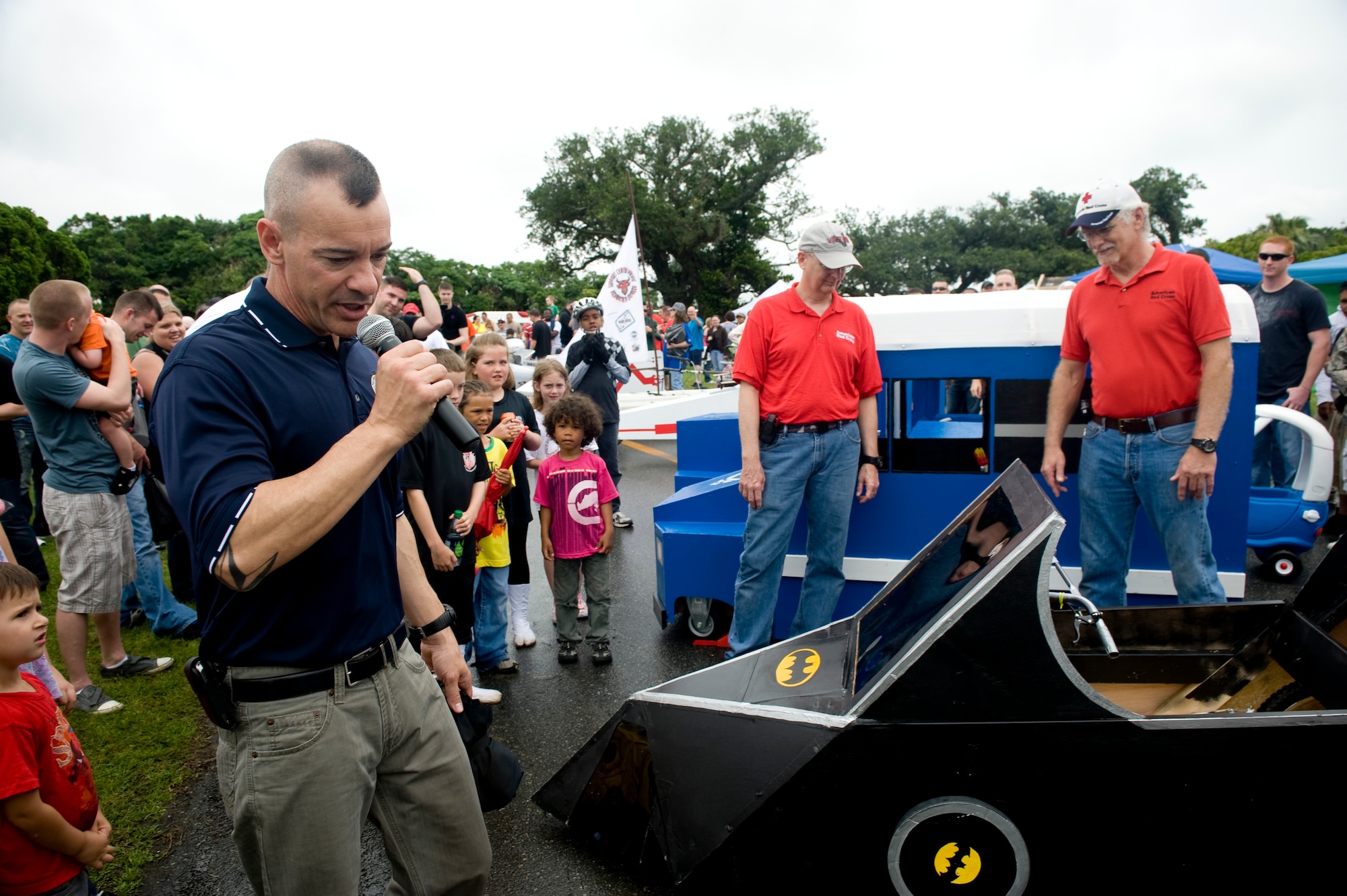 Chief Master Sgt. Mark Marson, 18th Wing, judges the derby cars for best in show at the Red Cross Derby Day at Kadena Air Base, Japan, April 24, 2012. The derby raised $5,200 for island-wide community service projects for U.S. service members and their families. (U.S. Air Force photo by Staff Sgt. Jonathan Steffen/Released)