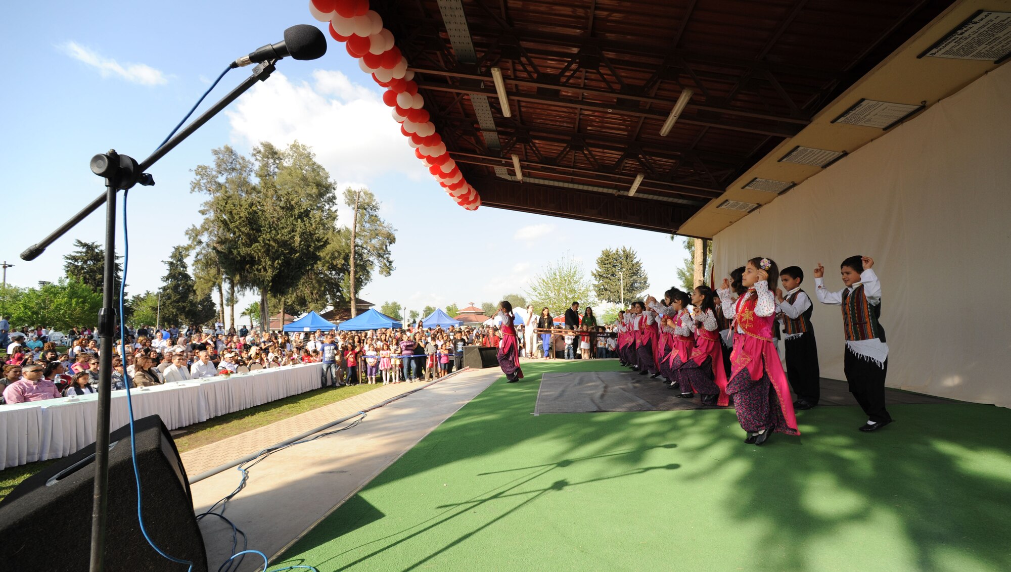 Children's Day festival participants perform a traditional Turkish dance during a festival April 22, 2012, at Incirlik Air Base, Turkey. The event was hosted by the Turkish air force 10th Tanker Base Command and was open to all Turkish and American members of Team Incirlik. The event offered an opportunity for camaraderie and building partnership between Turkish and American service members and civilians. Children's Day is a national holiday that honors Turkish children and the future of the country. (U.S. Air Force photo by Senior Airman Jarvie Z. Wallace/Released) 