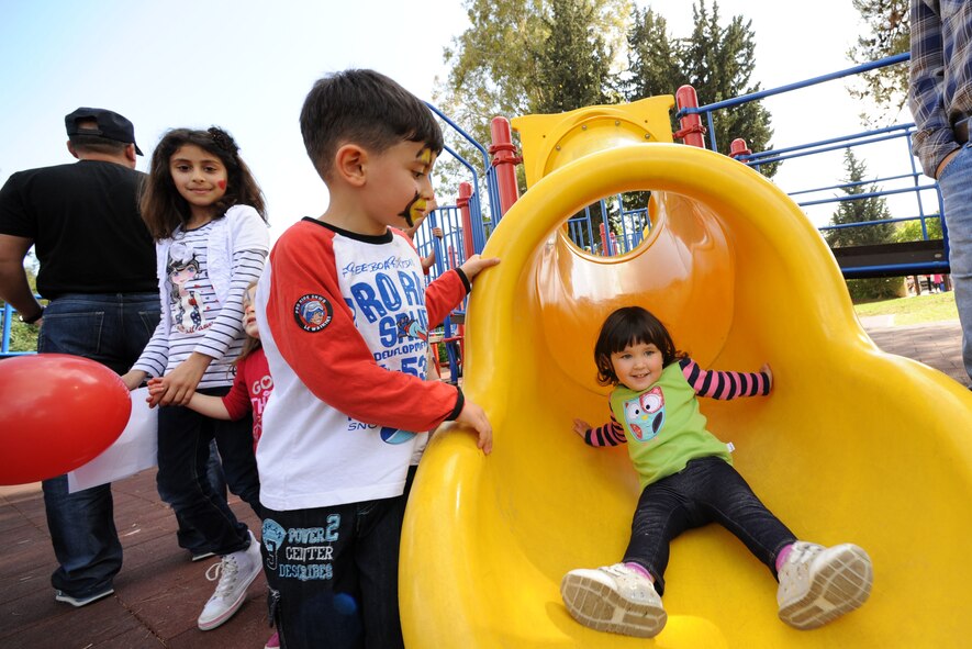 A boy watches his sister play in a tube slide during a Children's Day festival April 22, 2012, at Incirlik Air Base, Turkey. The event was hosted by the Turkish air force 10th Tanker Base Command and was open to all Turkish and American members of Team Incirlik. The event offered an opportunity for camaraderie and building partnership between Turkish and American service members and civilians. Children's Day is a national holiday that honors Turkish children and the future of the country. (U.S. Air Force photo by Senior Airman Jarvie Z. Wallace/Released) 