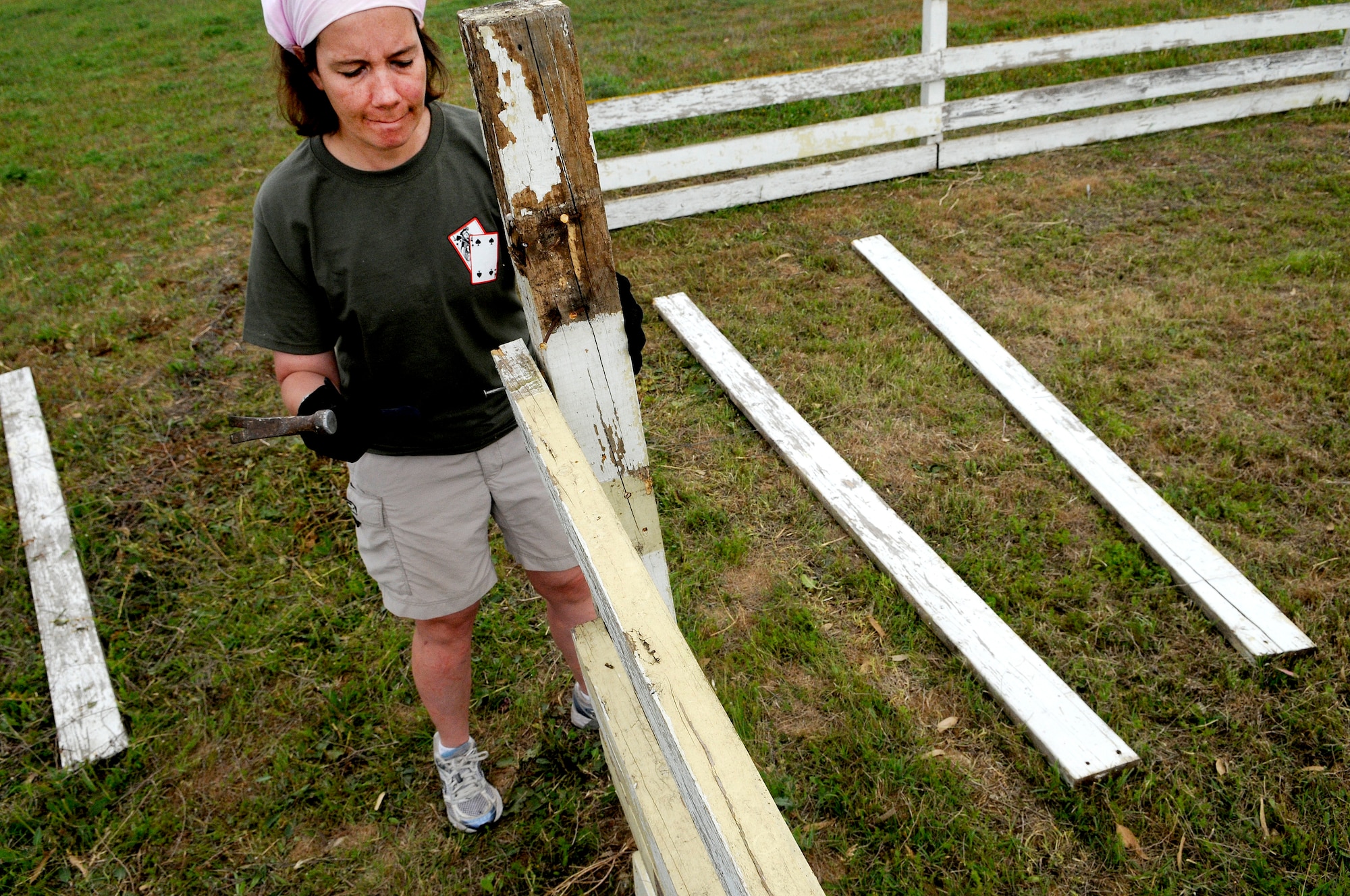 Jennifer Fletcher, 39th Air Base Wing, nails a board into a fence post at the base dog park April 21, 2012, at Incirlik Air Base, Turkey. Twelve volunteers spent five hours gathering trash and debris, mending fences, and mowing to provide a place for the base's furry residents to play. (U.S. Air Force photo by Staff Sgt. Kali L. Gradishar/Released)