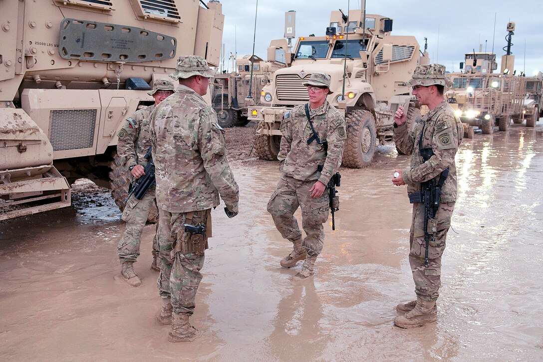 U.S. Army paratroopers gather after dawn on Forward Operating Base Arian
to board mine-resistant, ambush-protected vehicles to patrol along Highway 1 in Afghanistan's Ghazni province, April 20, 2012. Highway 1 is the country’s main thoroughfare between Kabul to the north and Kandahar to the south.