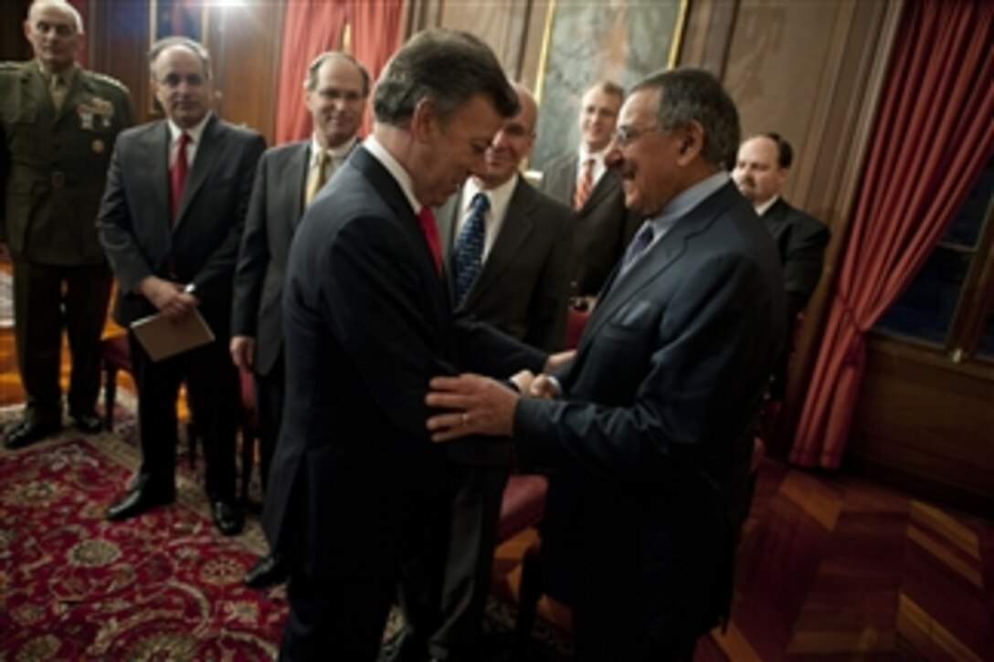 Secretary of Defense Leon E. Panetta greets Colombian President Juan Manual Santos in Bogota, Colombia, April 23, 2012.  Panetta is on a five-day trip to the region to meet with counterparts and military officials in Brazil, Colombia and Chile to discuss an expansion of defense and security cooperation.  