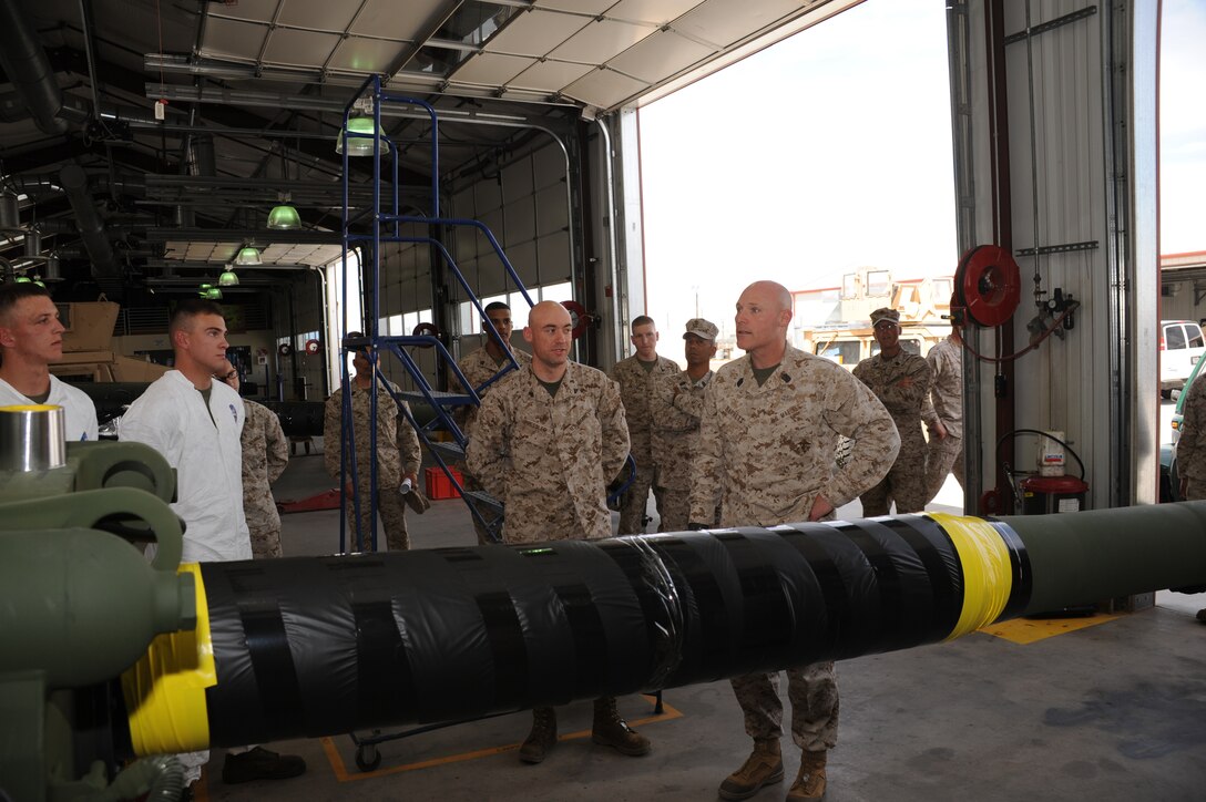Sergeant Major Micheal P. Barrett, Sergeant Major of the Marine Corps and Cpl. Michael Pressler, an artillery mechanic at Fleet Support Division, talk about the M777 155 mm howitzer aboard the Yermo annex of the base, April 24.