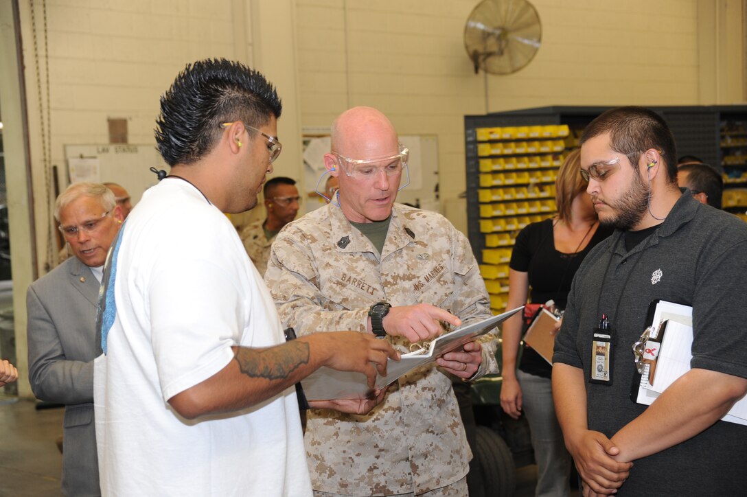 Workers with Marine Depot Maintenance Command, Barstow, explain to Sgt. Maj. Micheal P. Barrett, the functions and parts associated with the various pieces of equipment they use on a daily basis. This was the first visit to MCLB Barstow for the sergeant major.
